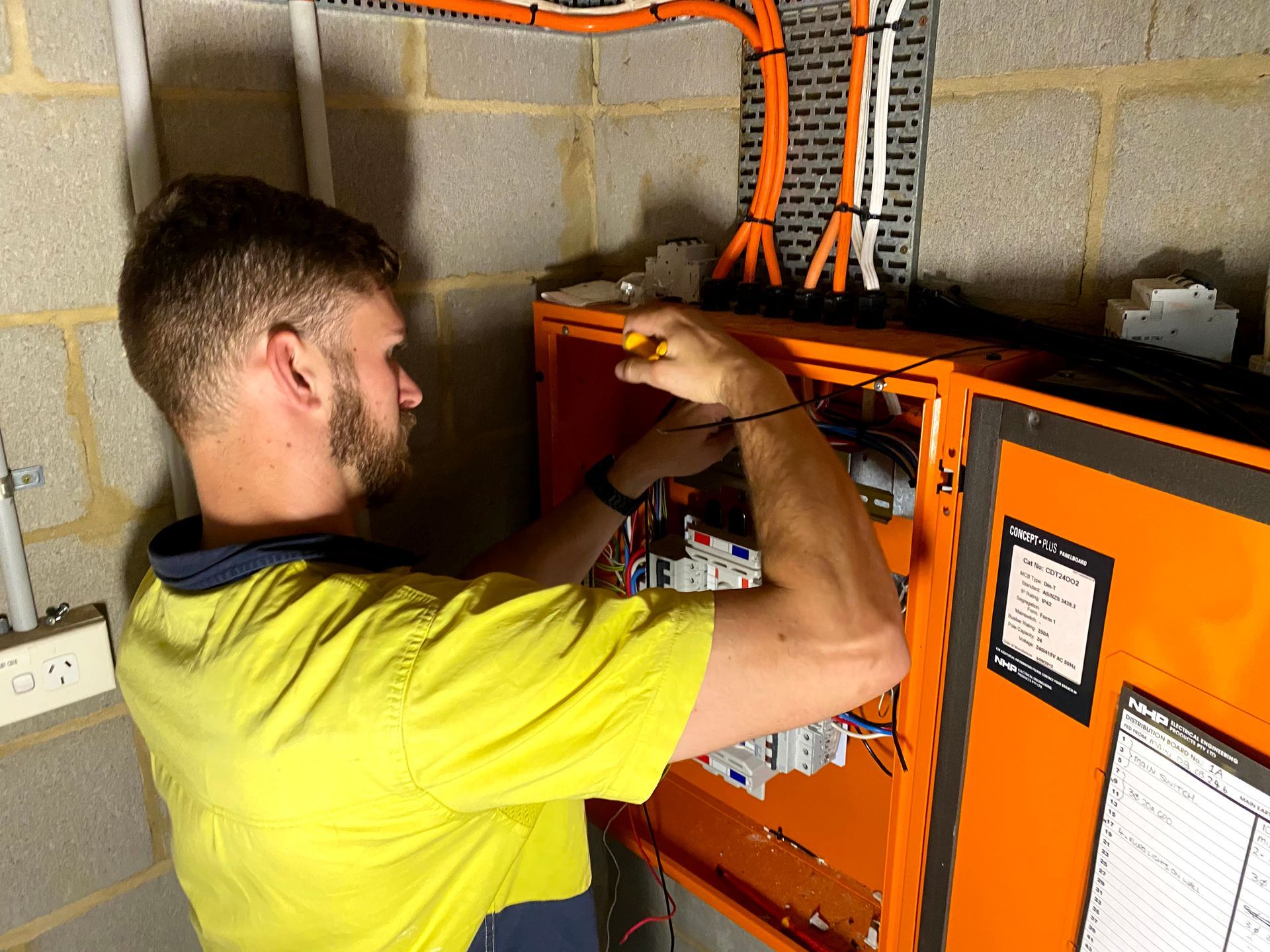 A Person is working on a switch board - Communications in Woy Woy, NSW