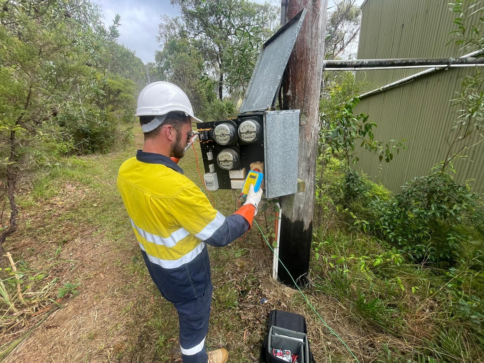A Man is Working on an Electrical Pole — TB Electrical & Communications in Erina, NSW