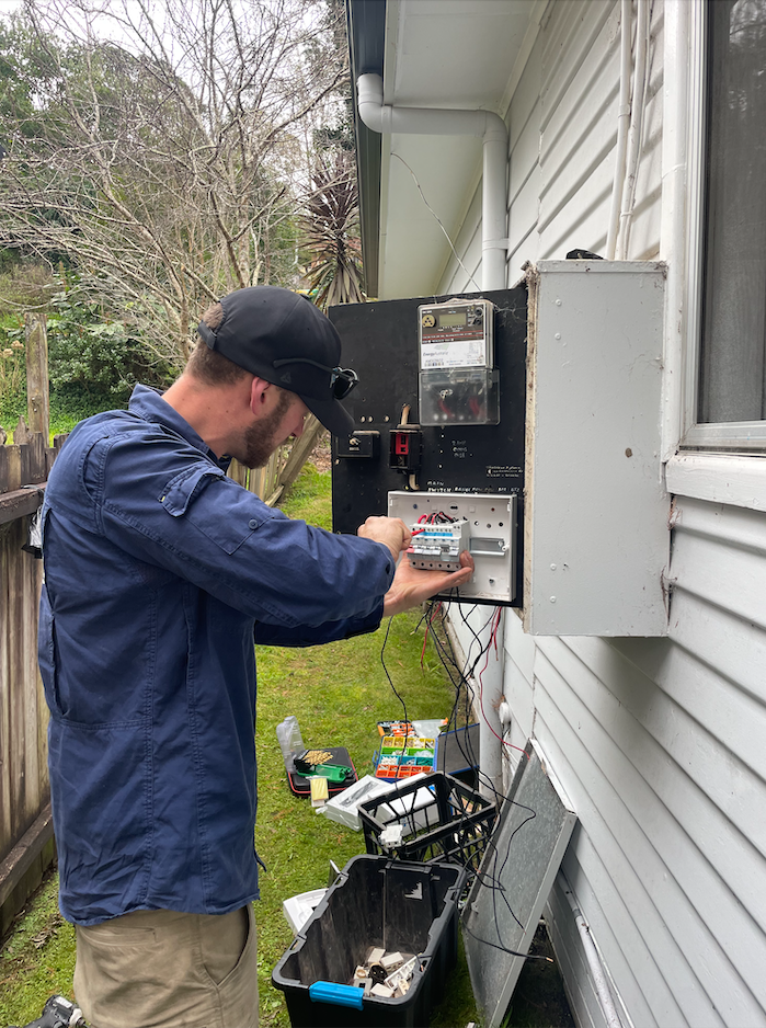 Young Electrician At Work Measure The Voltage Of A Residential Electrical Installation — TB Electrical & Communications in Erina, NSW