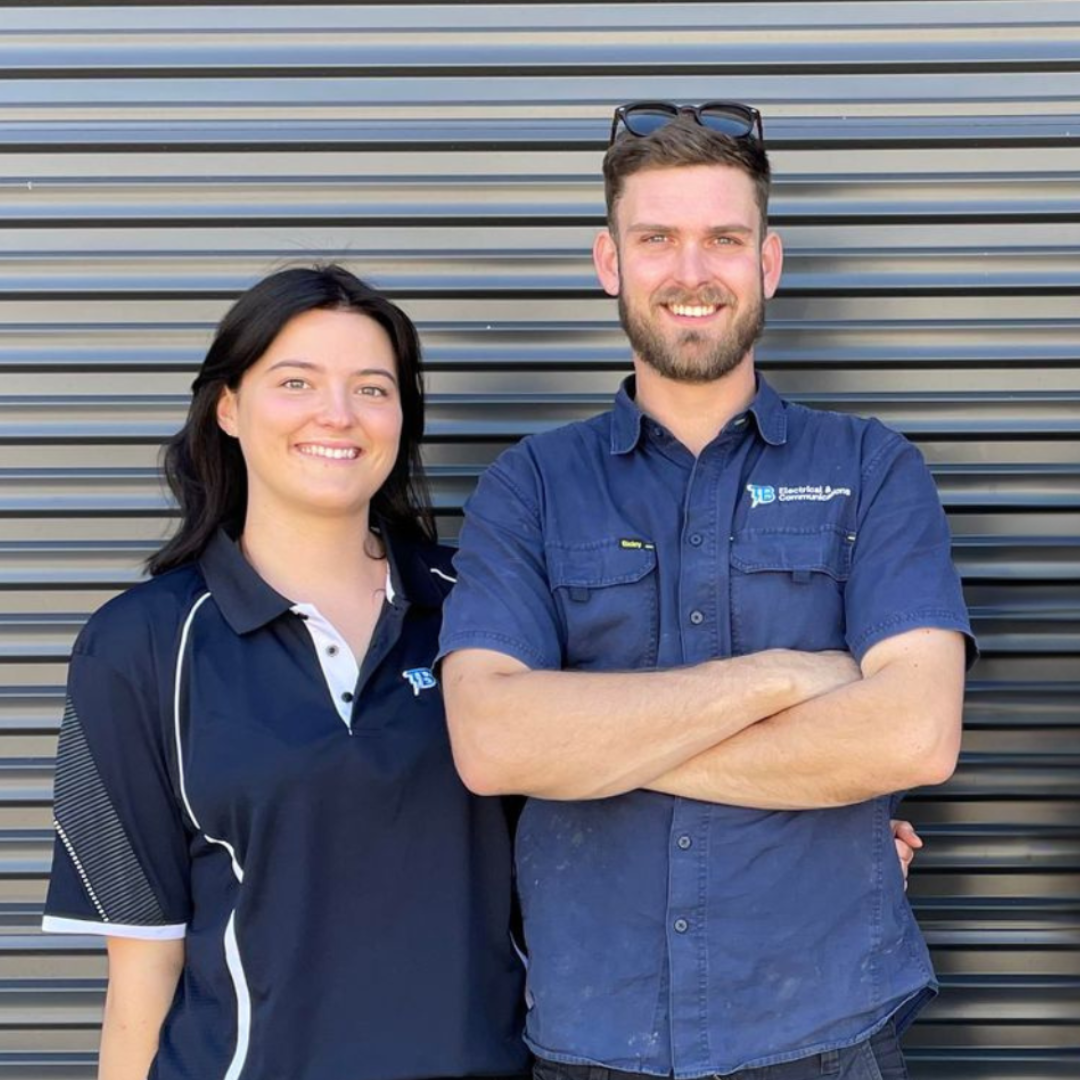 A Man And A Woman Standing In Front Of A Door— TB Electrical & Communications in Erina, NSW
