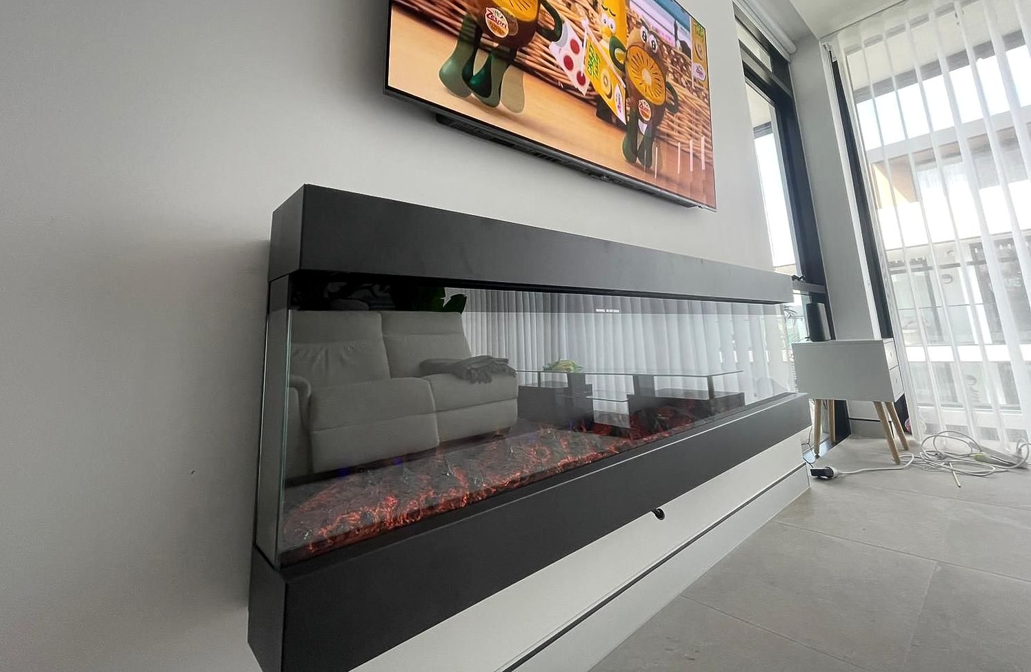 A Living Room With An Electric Fireplace — TB Electrical & Communications in Erina, NSW