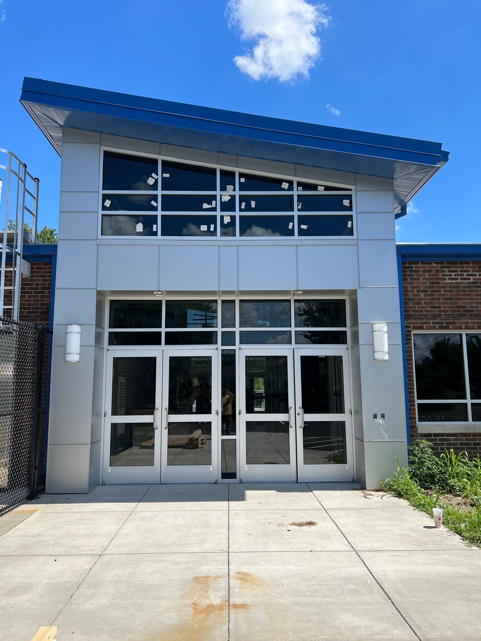 a building with a blue roof and a lot of windows