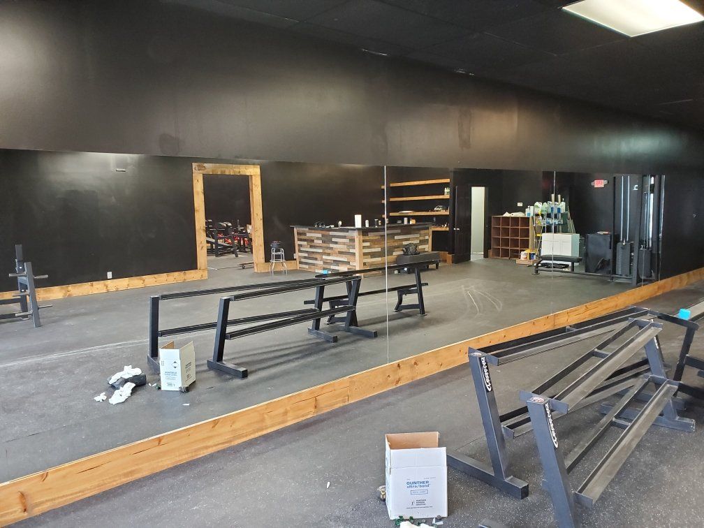 a gym with a large mirror and a box that says safeco on it