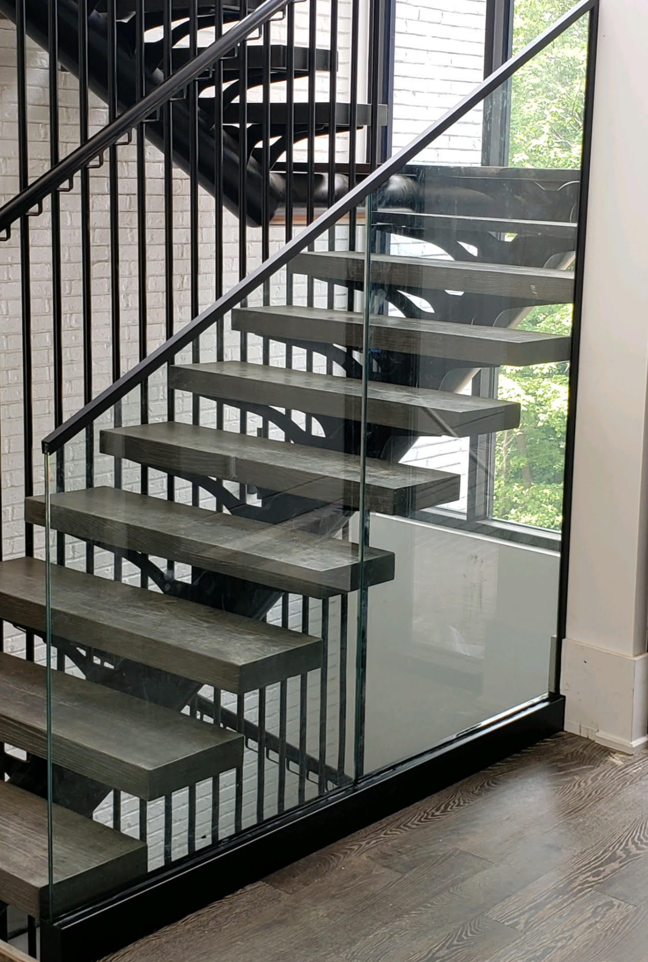 a staircase with wooden steps and a glass railing