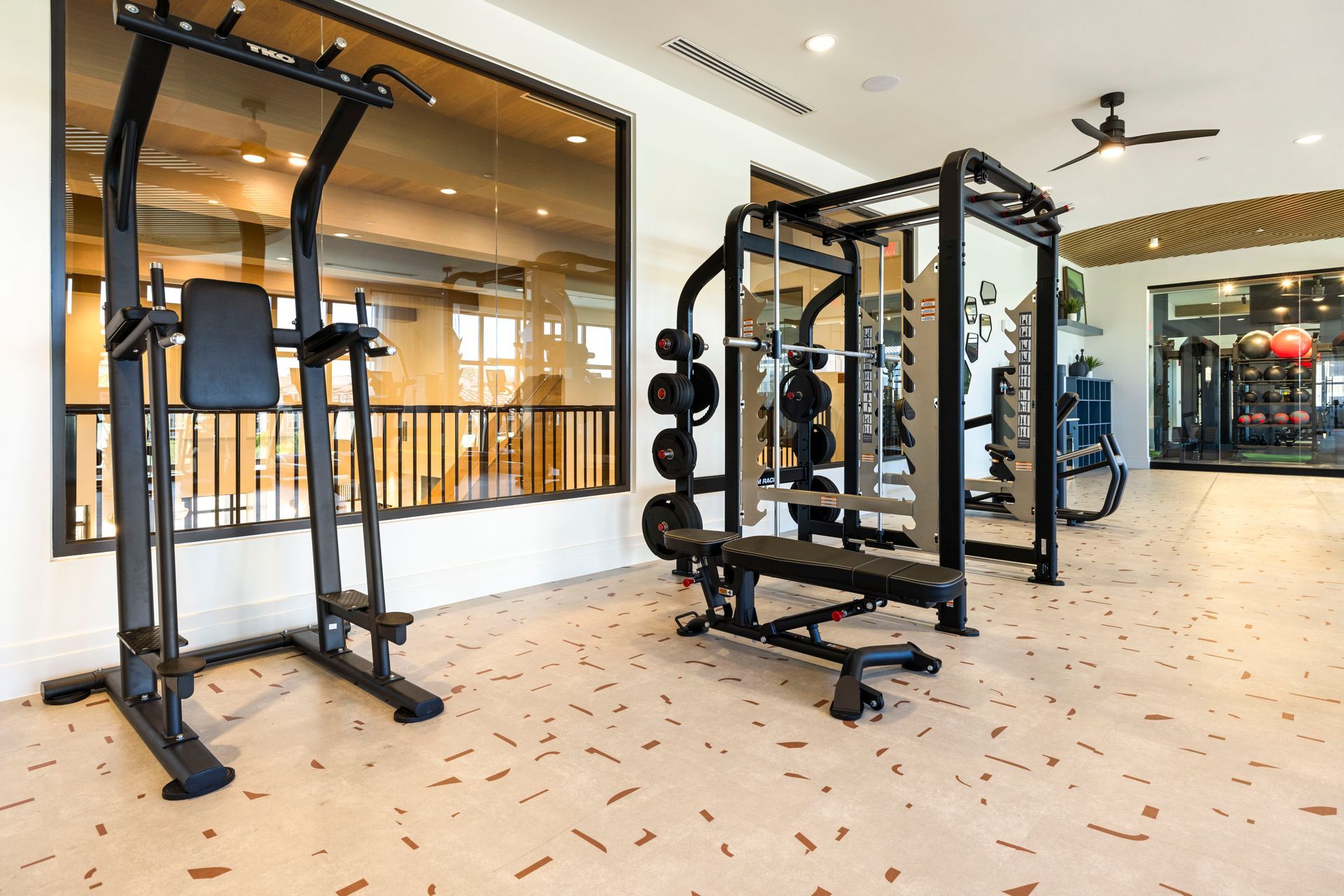 A gym with a lot of exercise equipment on the floor at Corsa at Estero Crossing.