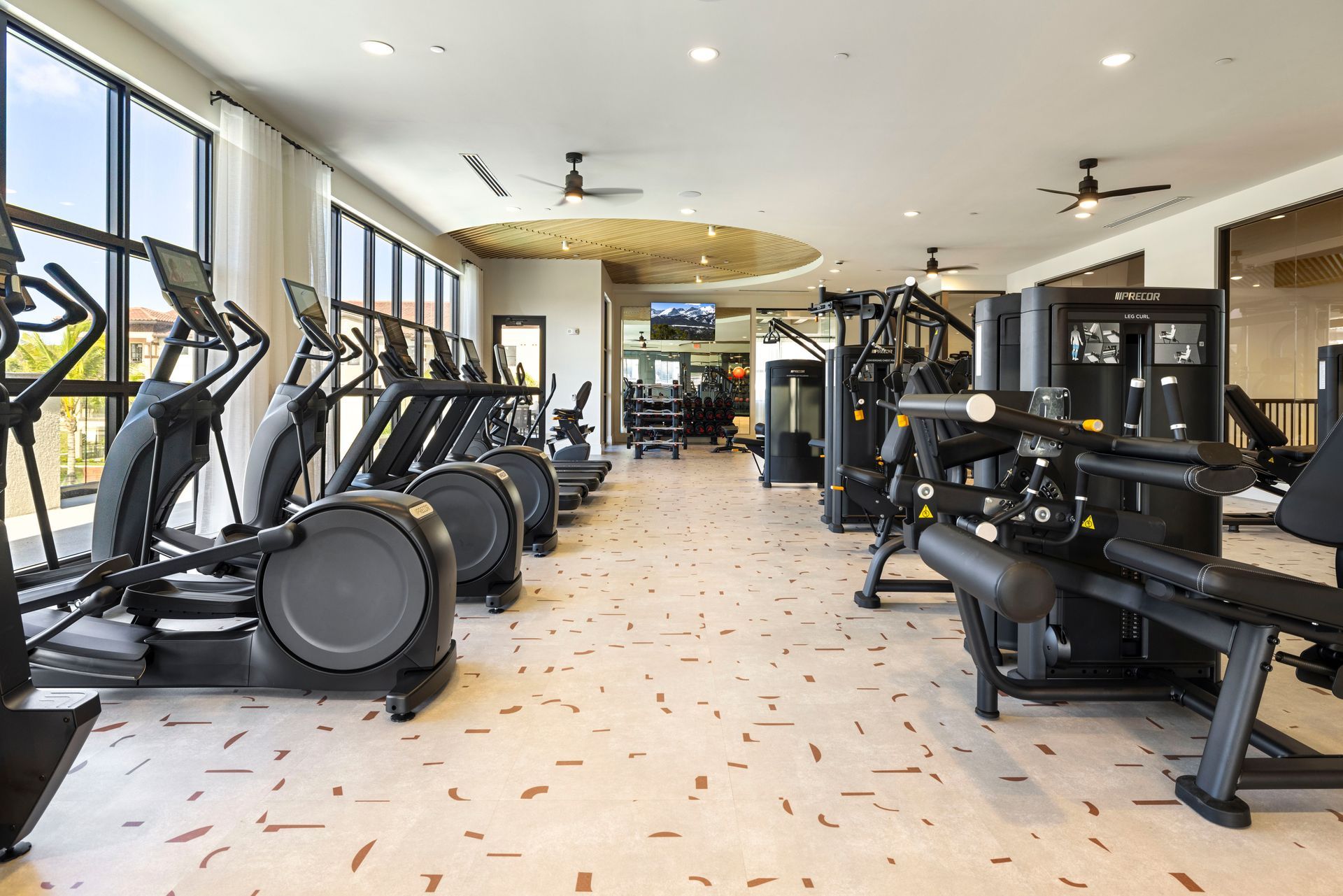 A large gym filled with lots of exercise equipment at Corsa at Estero Crossing.