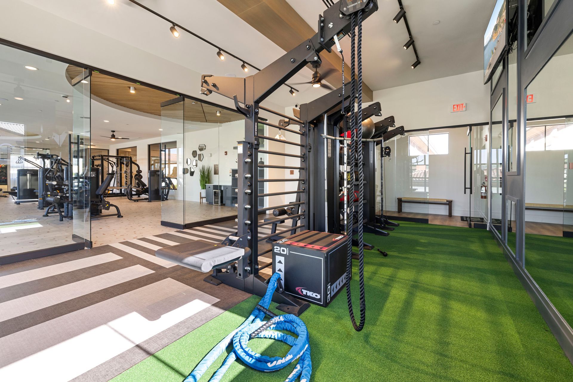 A gym with a lot of exercise equipment and a rope at Corsa at Estero Crossing.