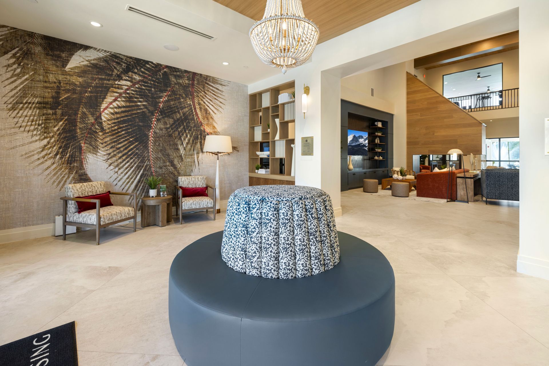 There is a large round ottoman in the middle of the room at Corsa at Estero Crossing.