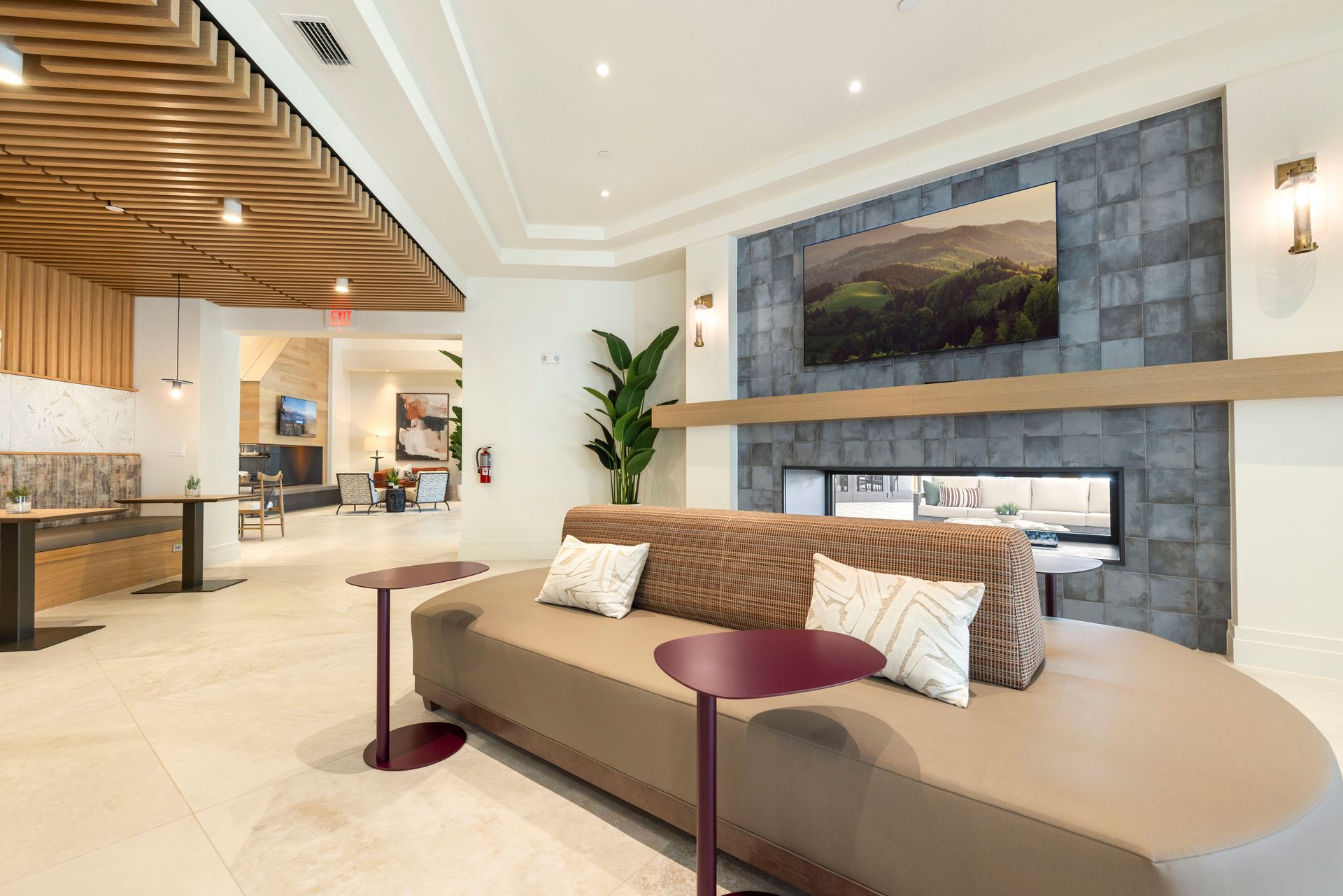 A living room with a couch , two tables and a fireplace at Corsa at Estero Crossing.