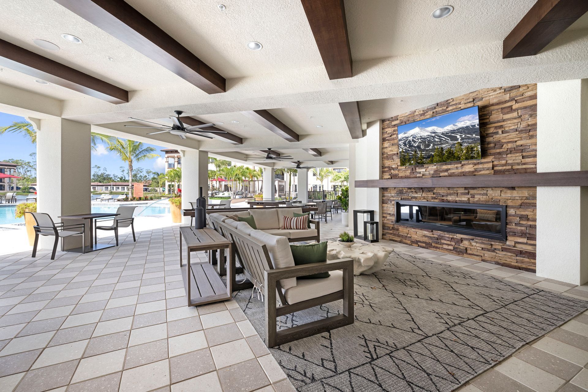 A living room with a fireplace and a television at Corsa at Estero Crossing.