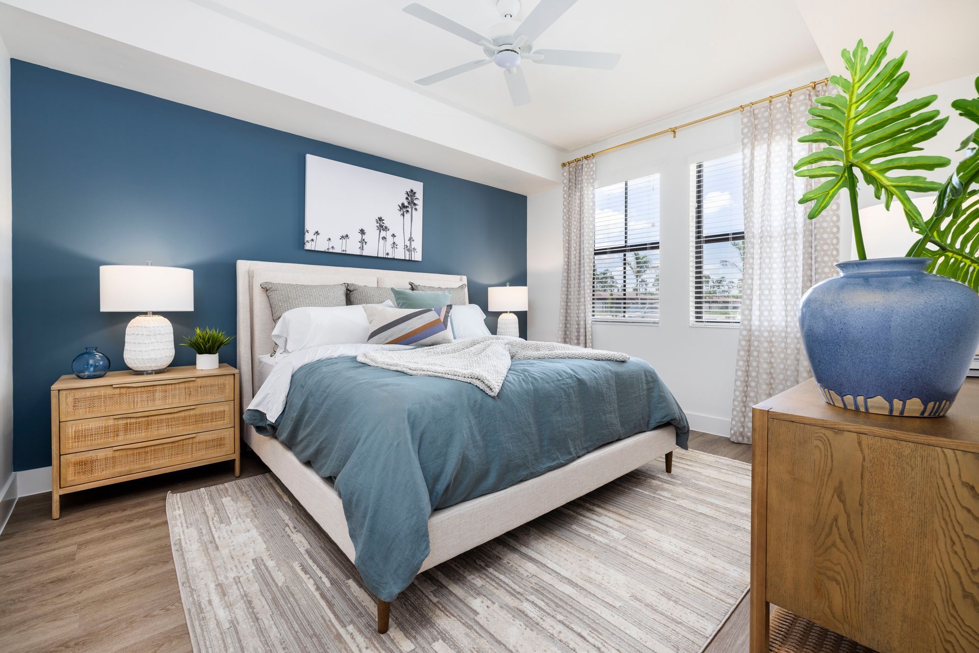 A bedroom with a large bed and a ceiling fan at Corsa at Estero Crossing.