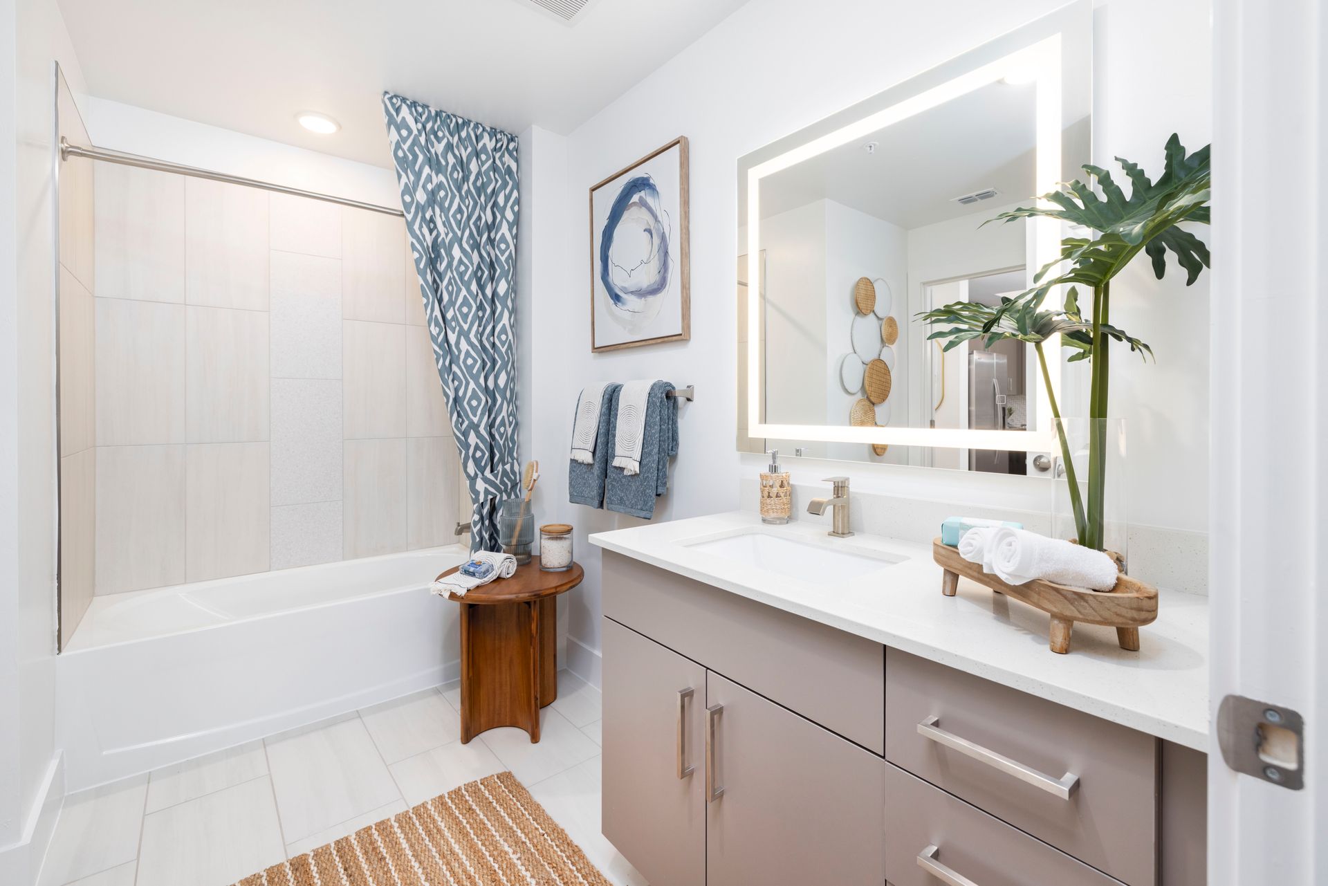 A bathroom with a sink , tub and mirror at Corsa at Estero Crossing.