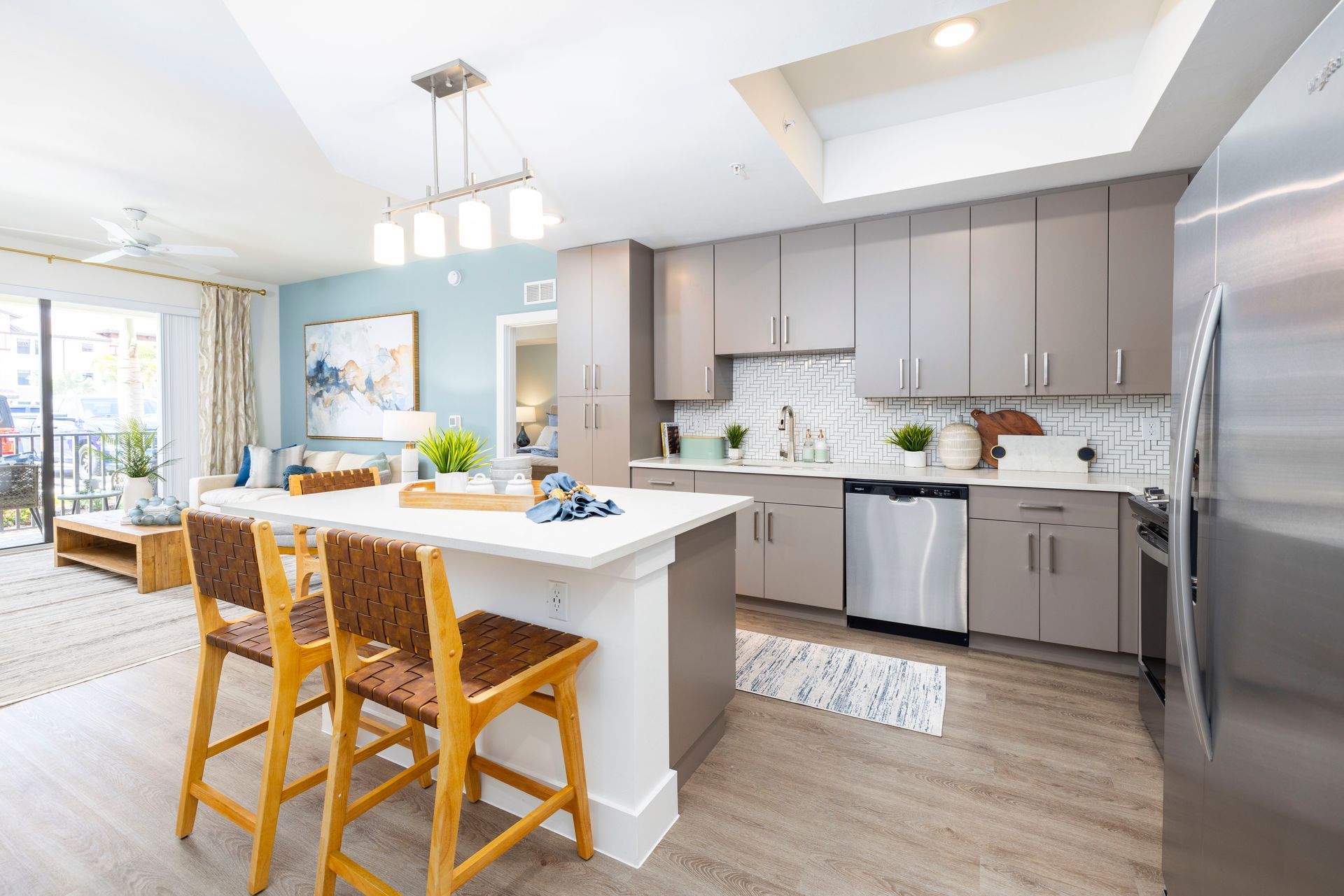 A kitchen with stainless steel appliances and a large island at Corsa at Estero Crossing.