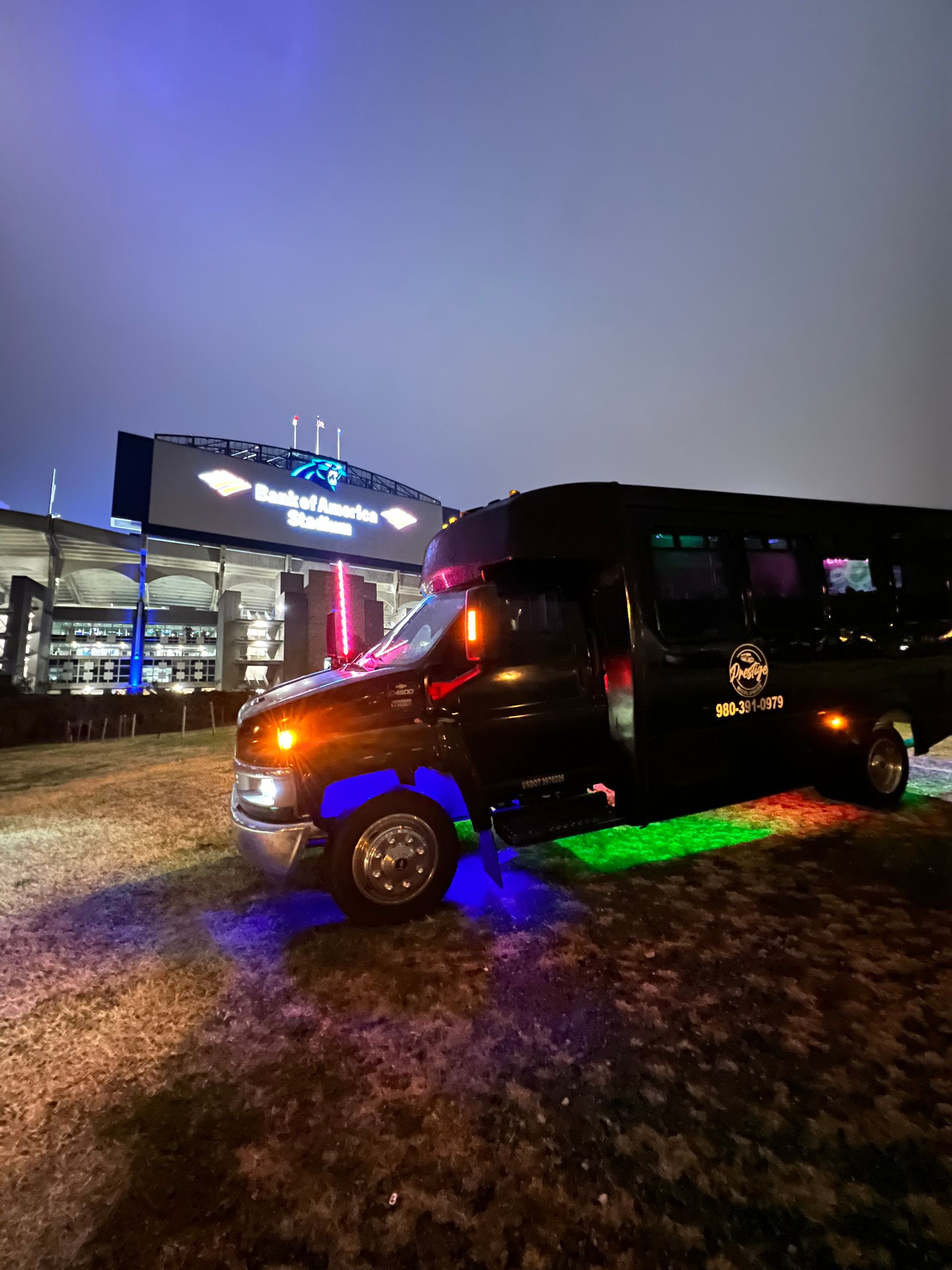 A black van is parked in front of a building