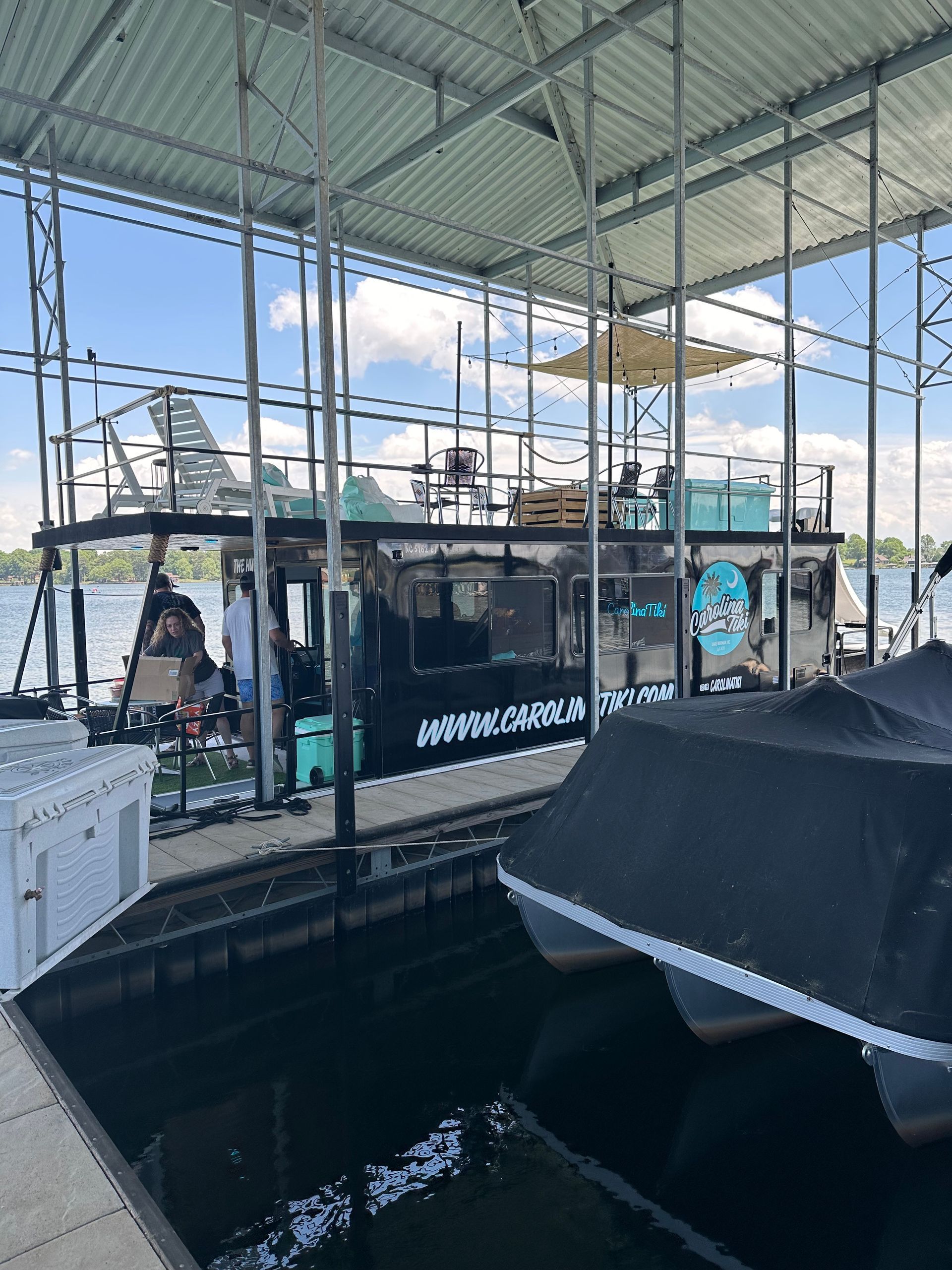 A boat is docked in a dock next to a body of water.