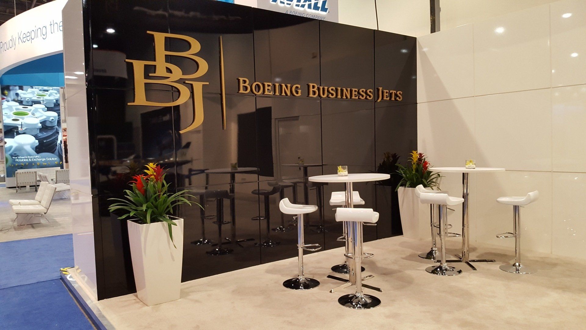 A boring business jets booth with tables and chairs