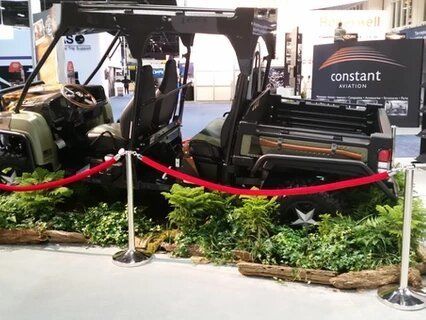 A constant motors vehicle is on display at a convention