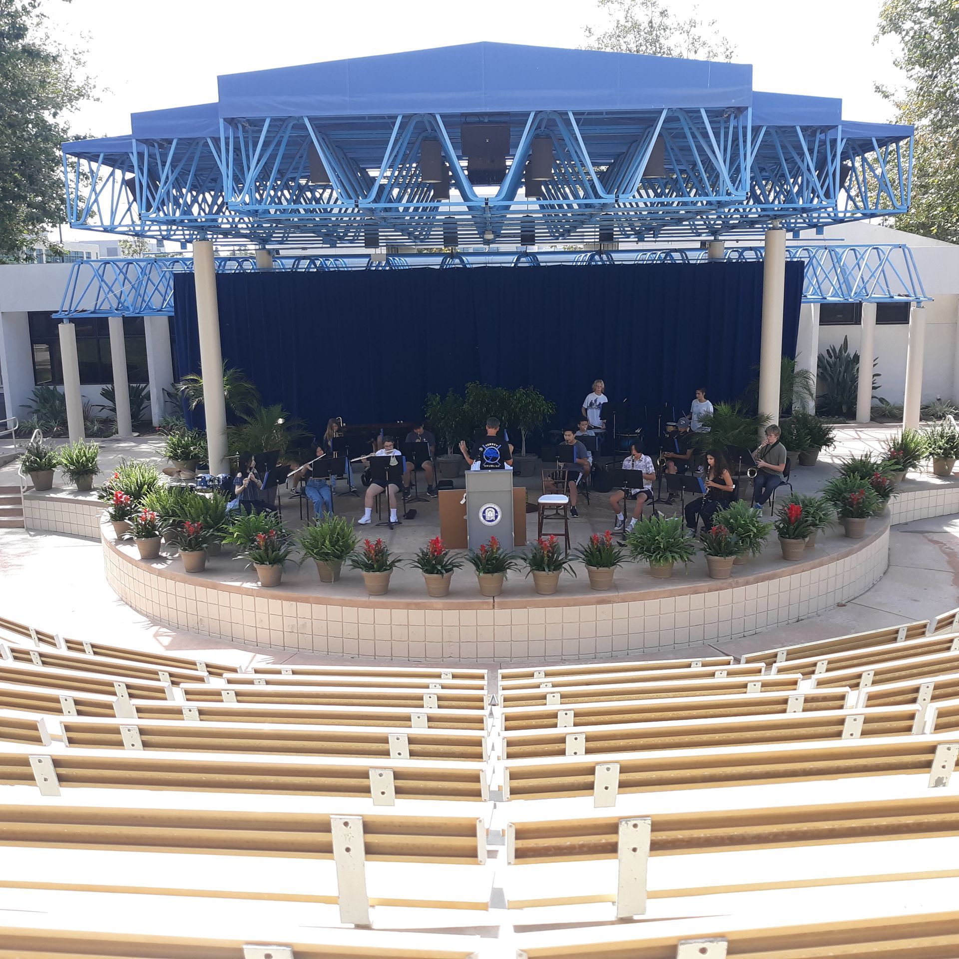 A group of people are sitting on a stage in an amphitheater