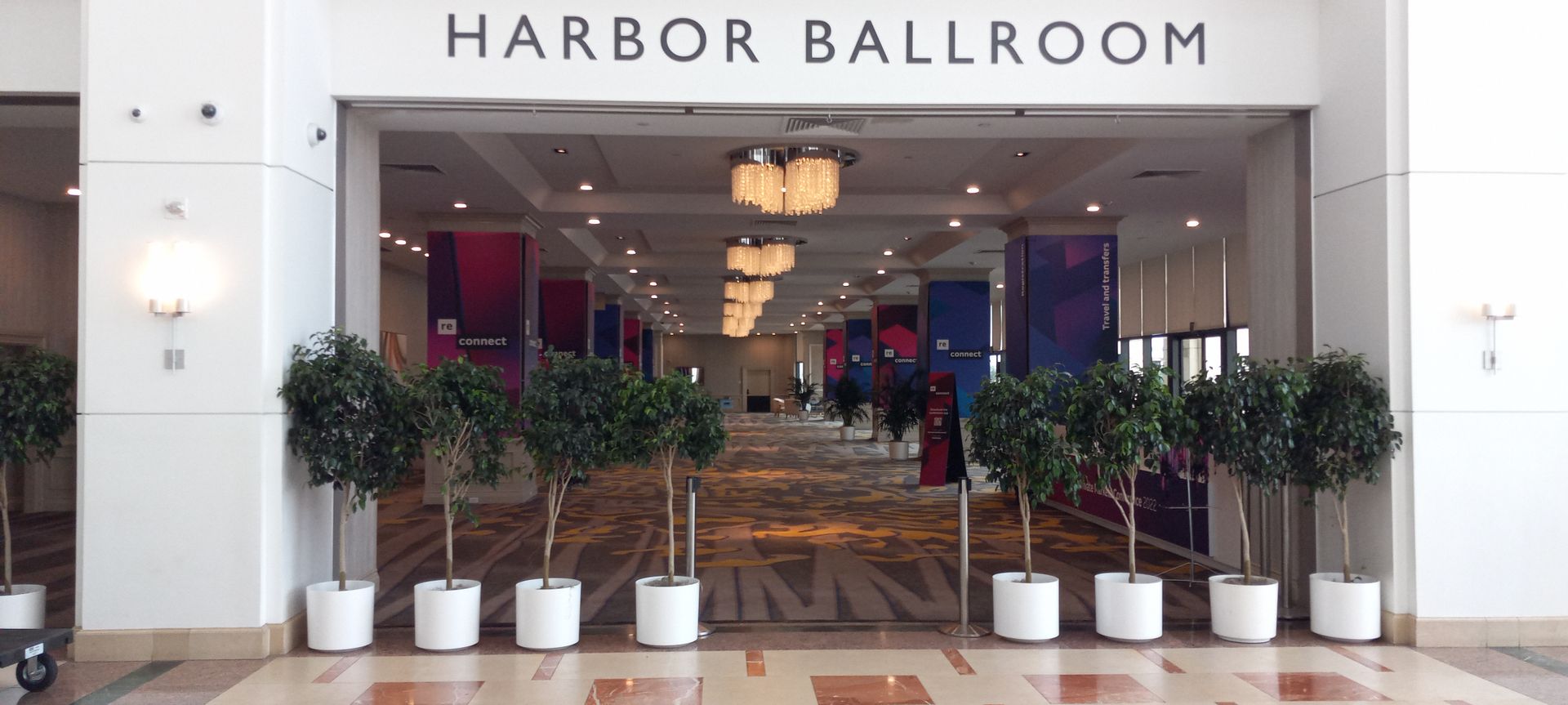 A large hallway with a sign that says harbor ballroom
