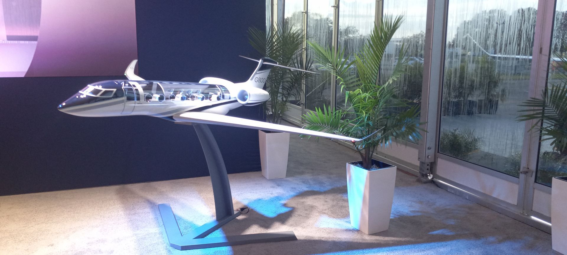 A model airplane is sitting on top of a table in a room.