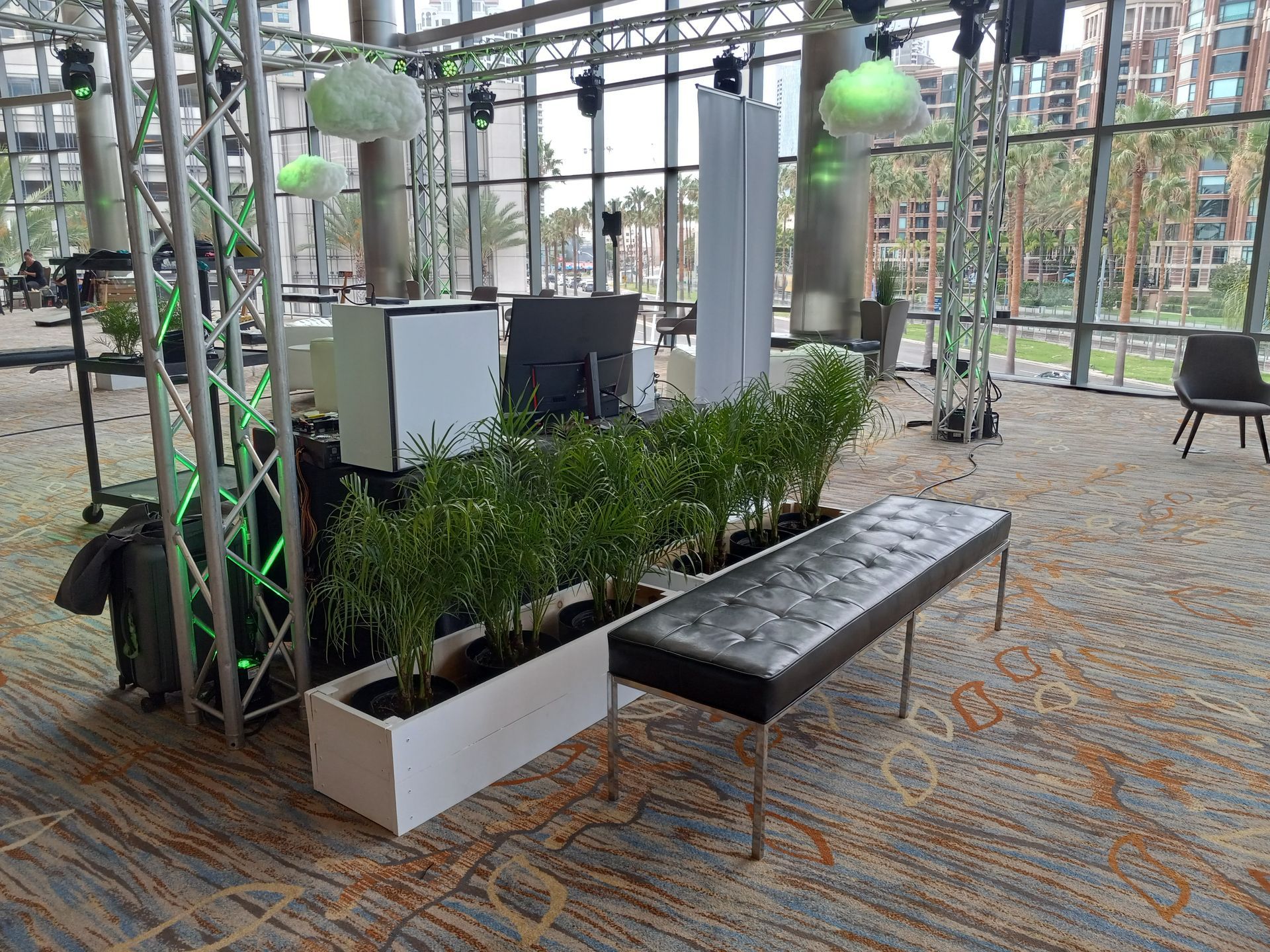 A room with a bench and a planter filled with plants.