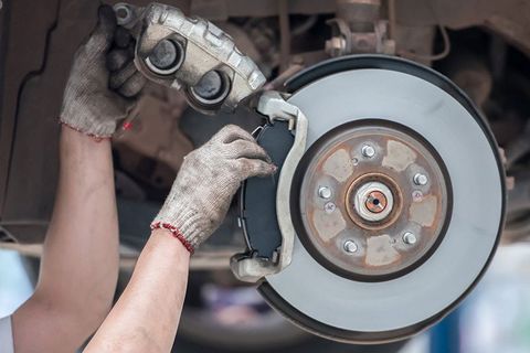 Car Mechanic Repairing Brakes On Car — Woolcock Automotive In  Townsville QLD