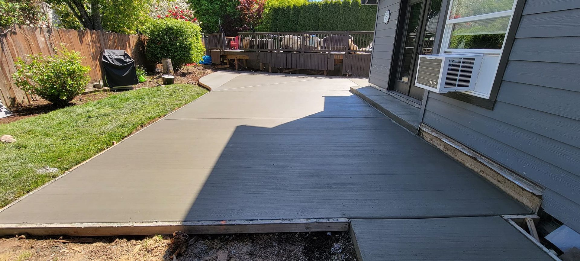 A concrete walkway is being built in front of a house.