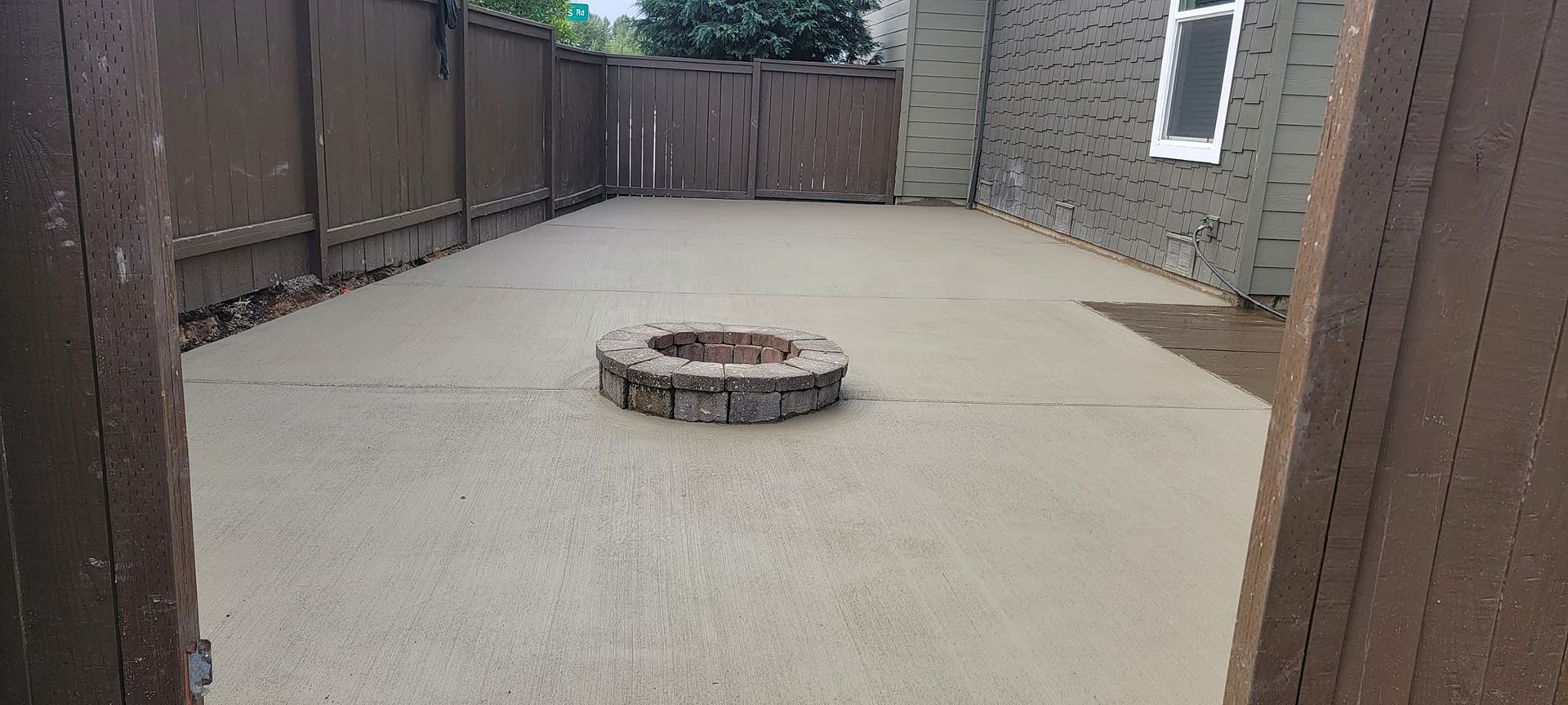 There is a fire pit in the middle of the backyard.
