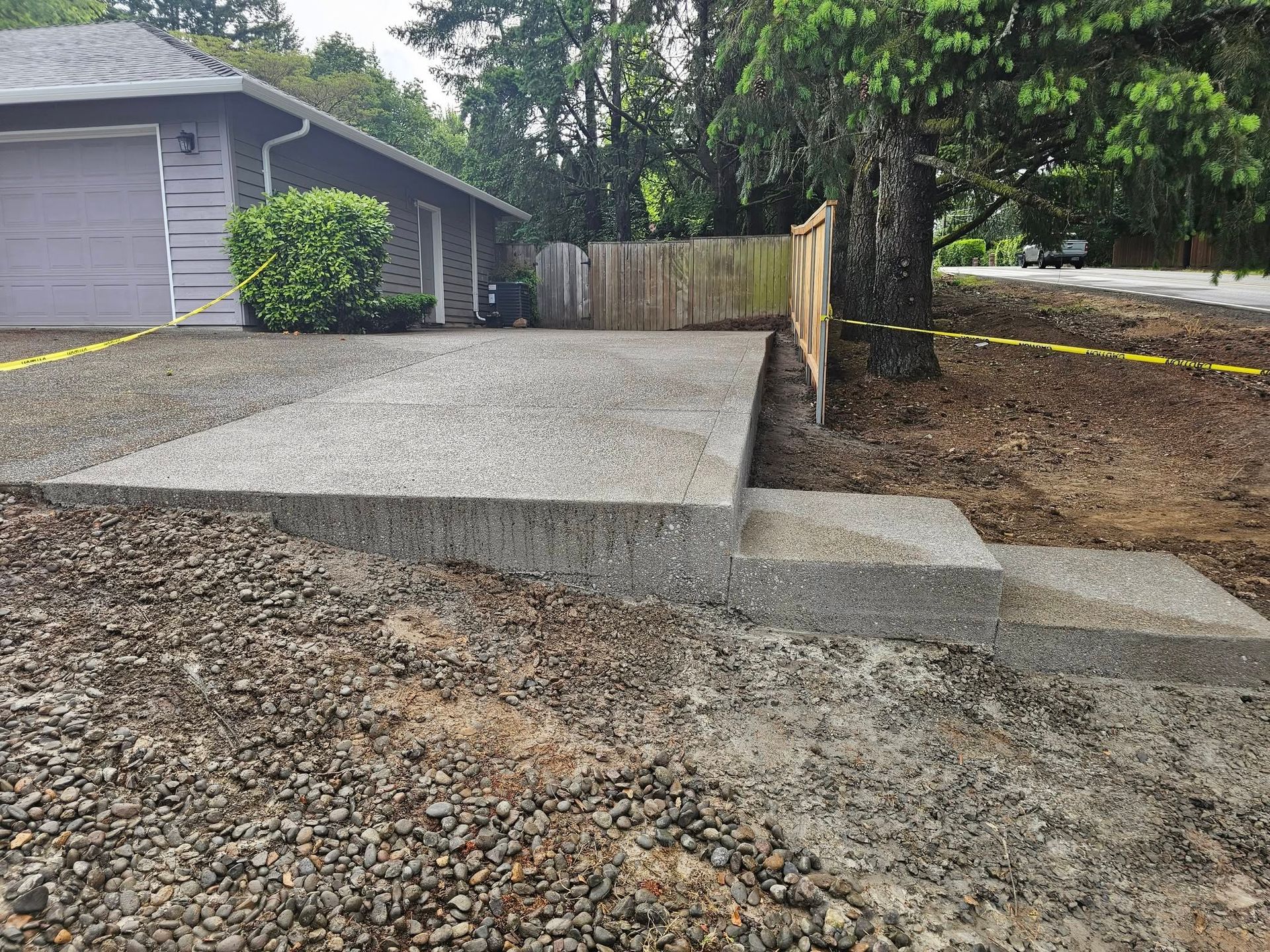 A concrete driveway is being built in front of a house.