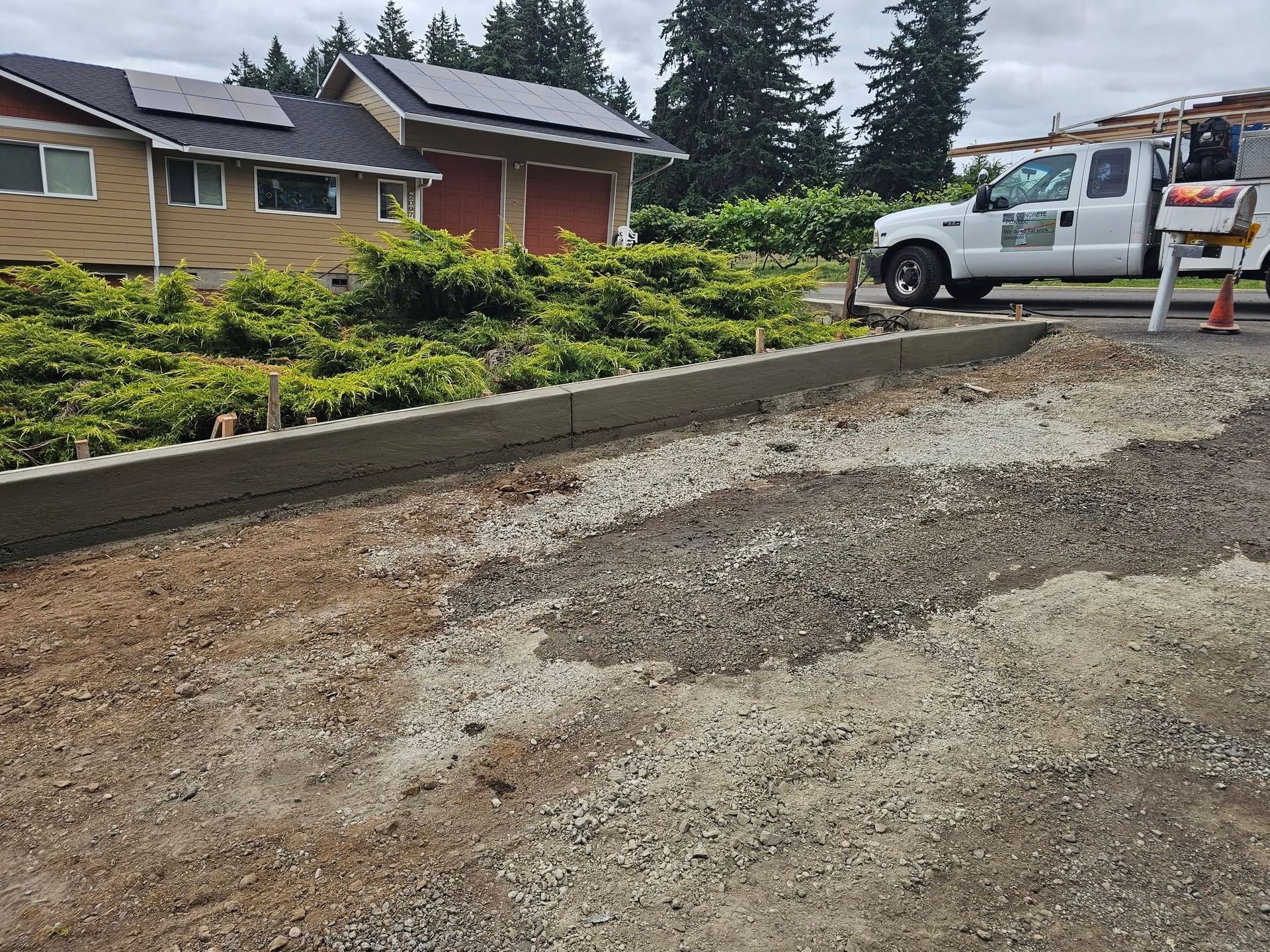 A white truck is parked in front of a house.