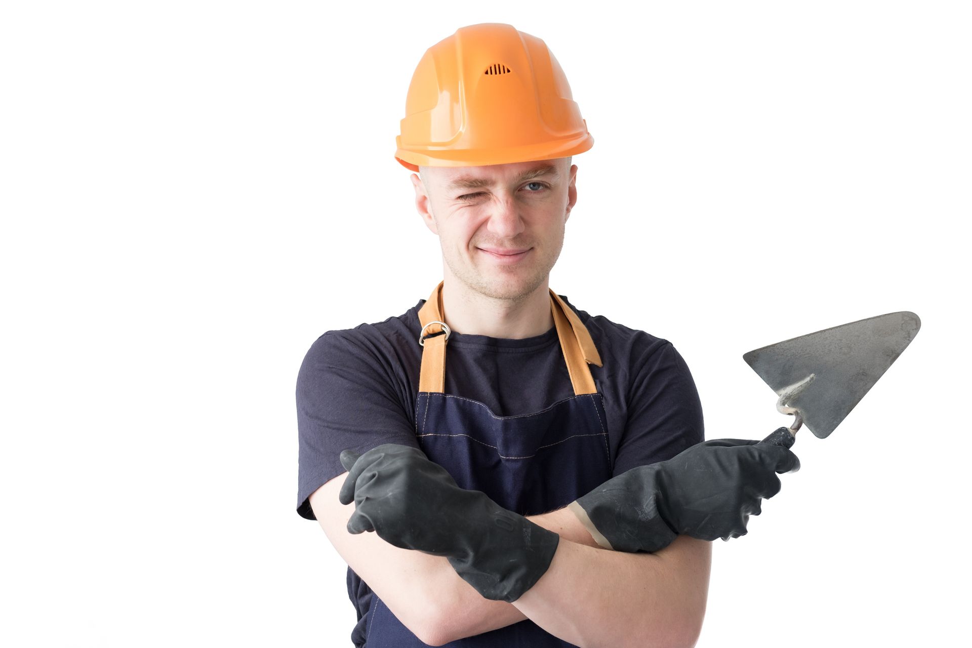 A man wearing a hard hat and apron is holding a trowel.