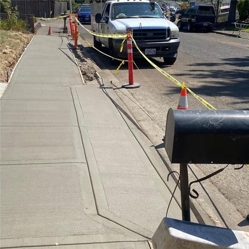 A sidewalk with a fire hydrant on the side of it.