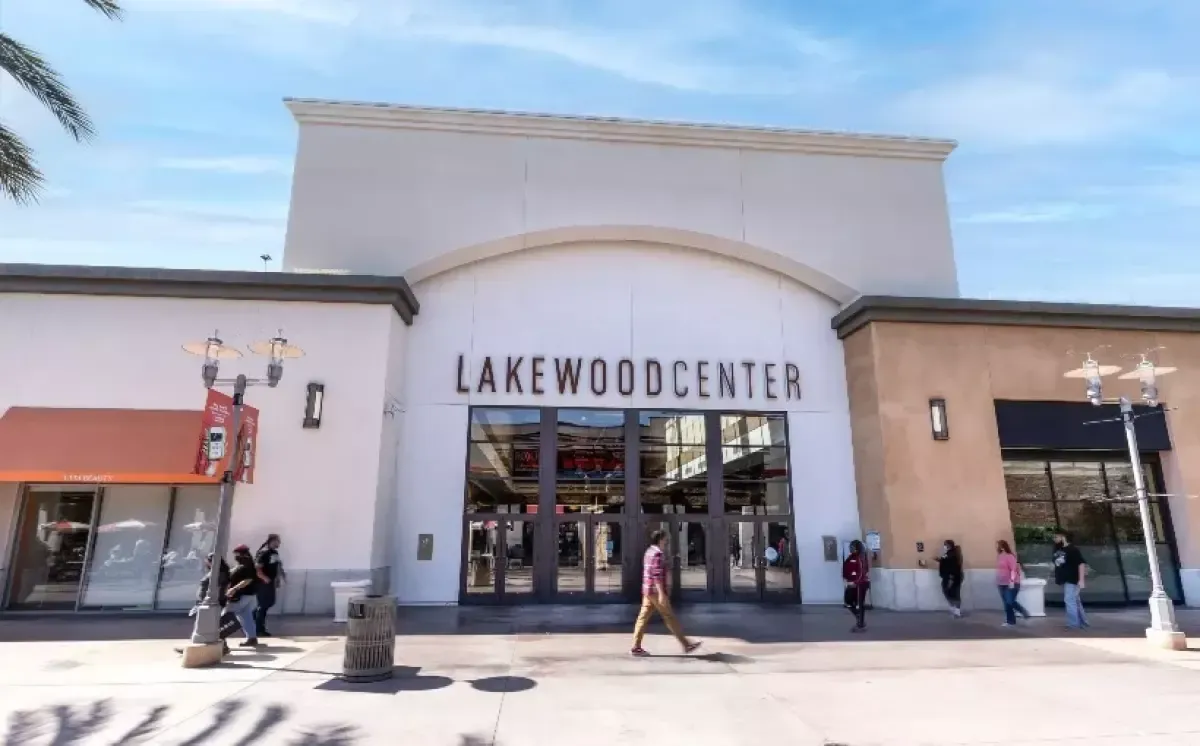 Building exterior with a grassy lawn and trees.