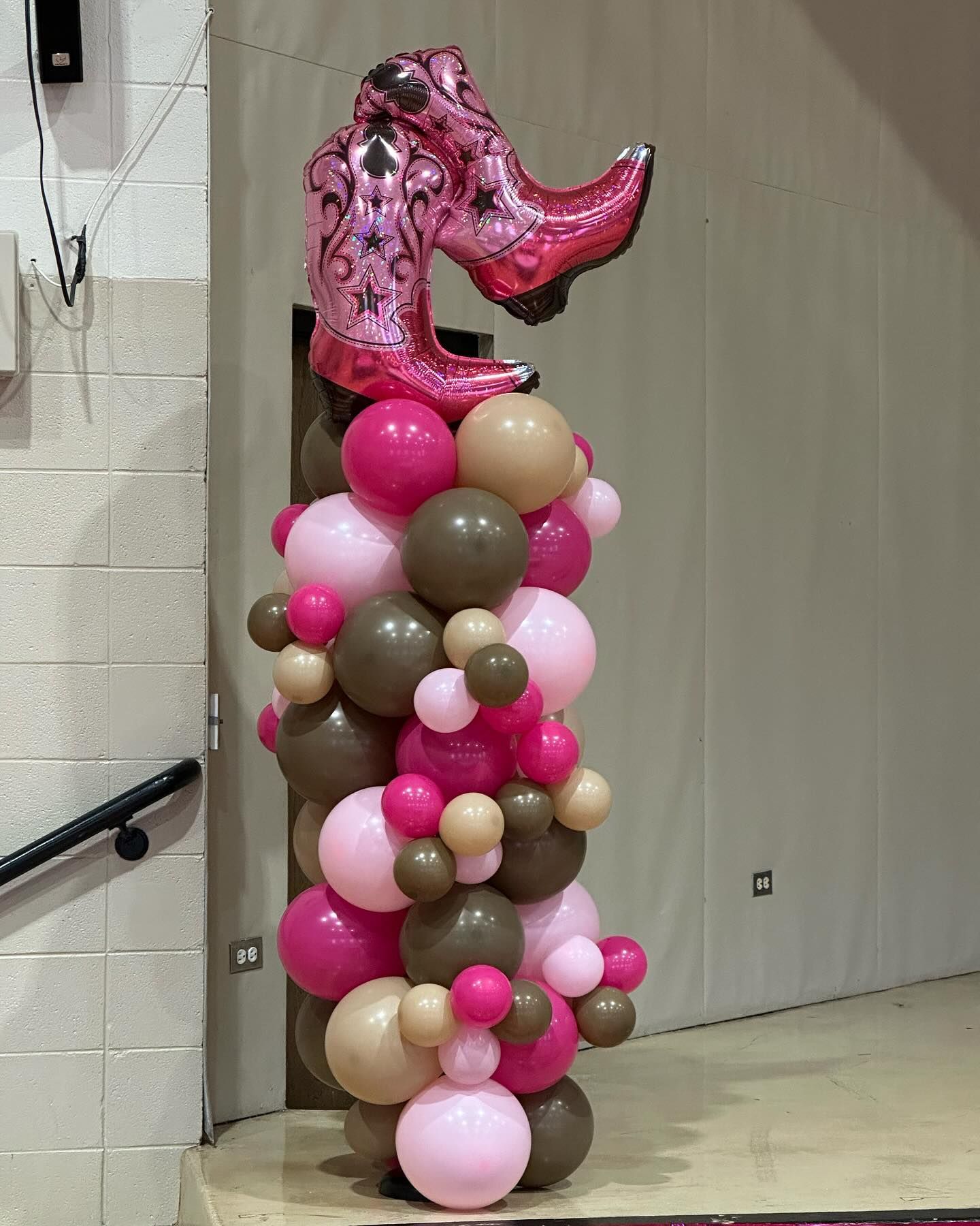 A balloon with a pair of cowboy boots on top of it