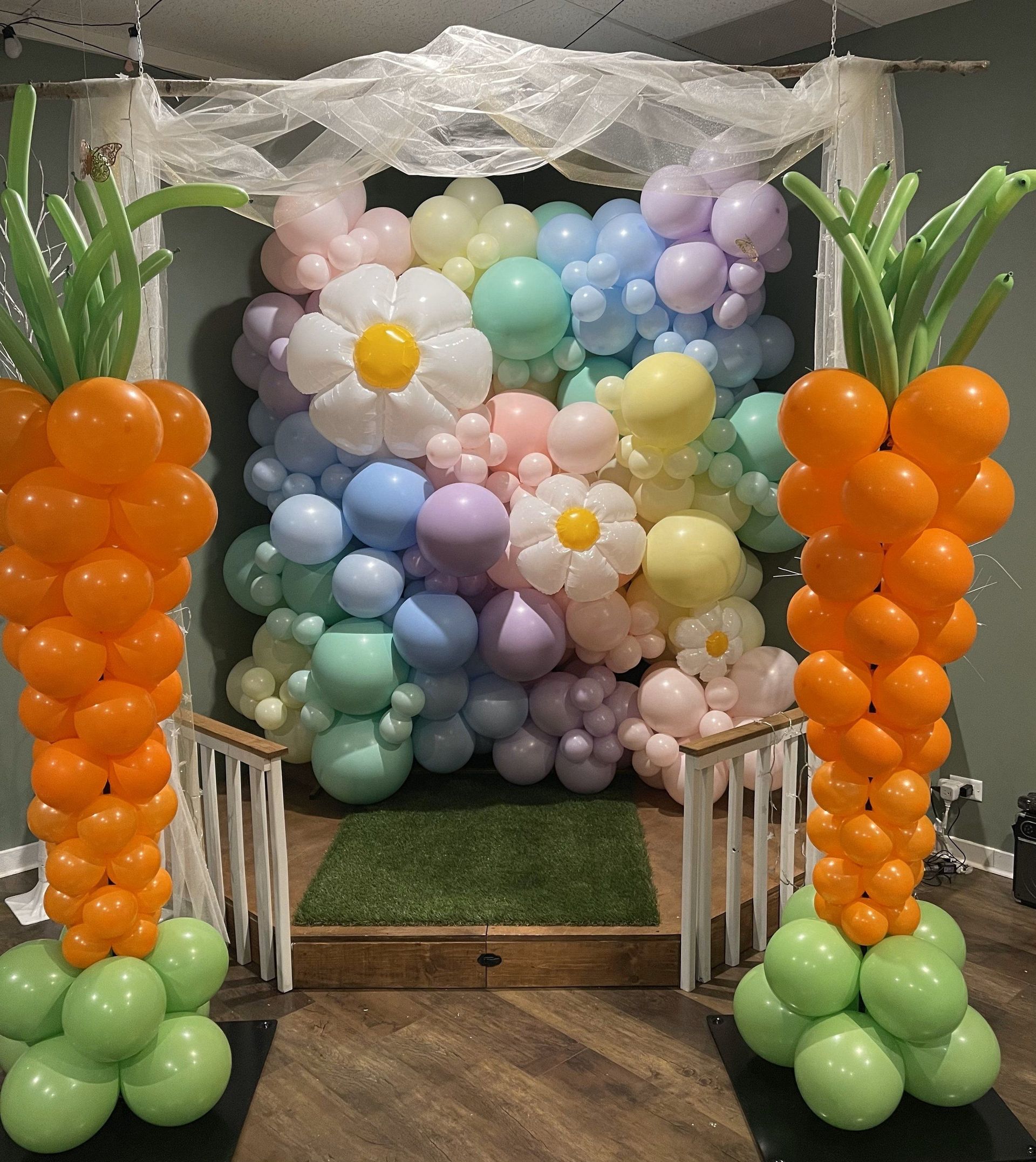 A bunch of balloons in the shape of carrots and pineapples
