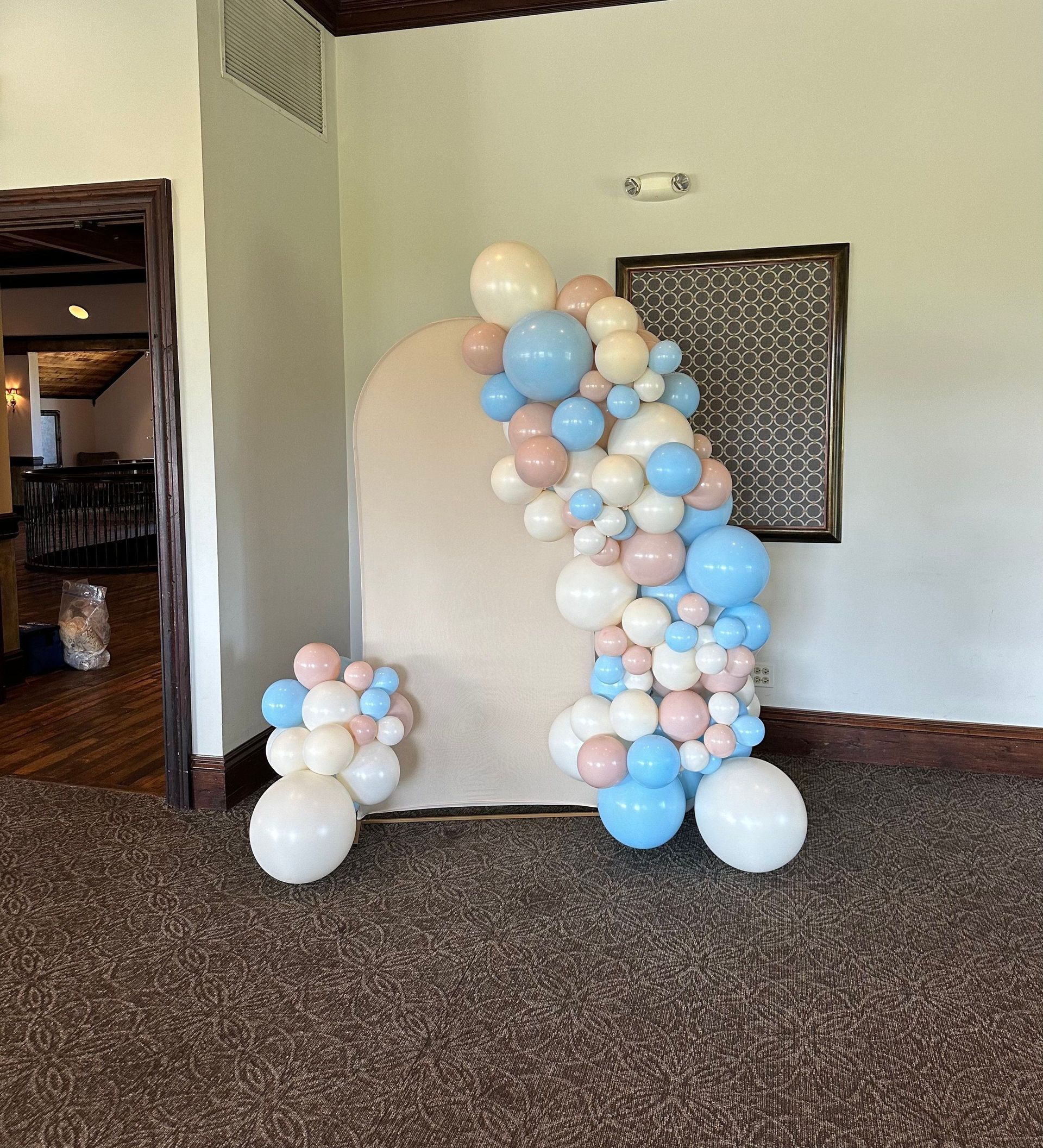 A bunch of balloons are sitting on the floor in a room