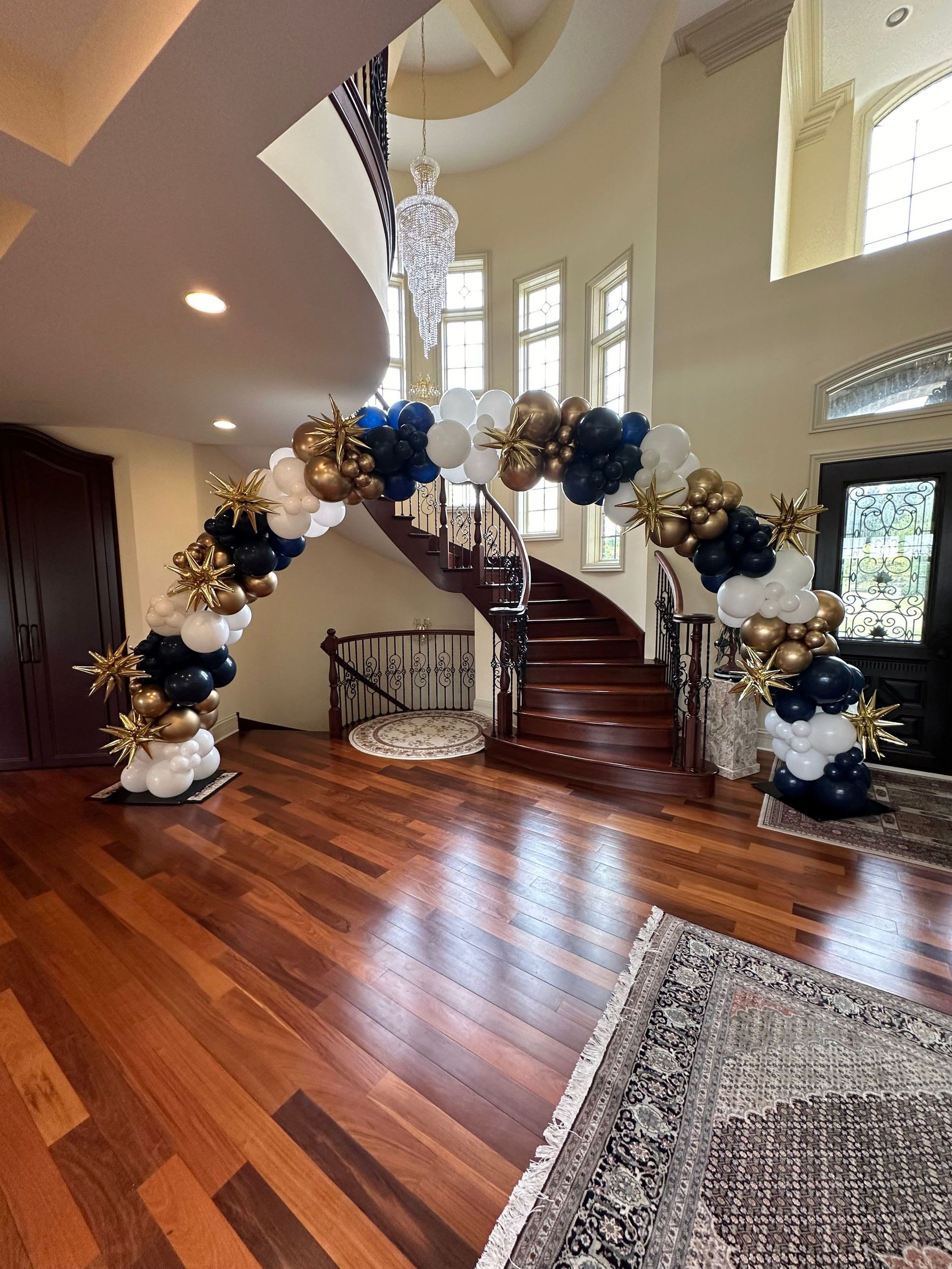 A large room with a staircase and balloons on the floor.