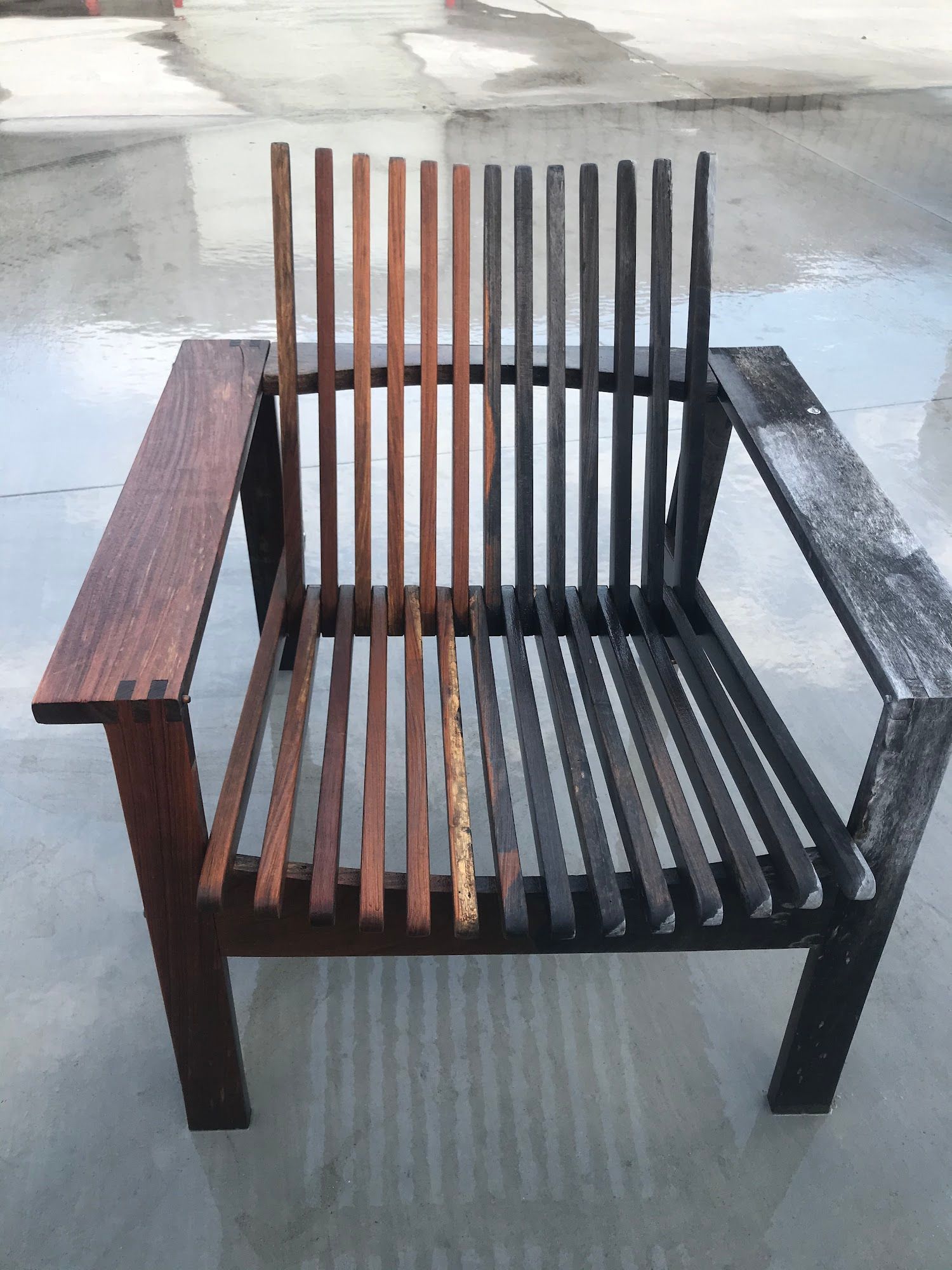 Wooden chair, partially stained, showing color comparison of different treatments.