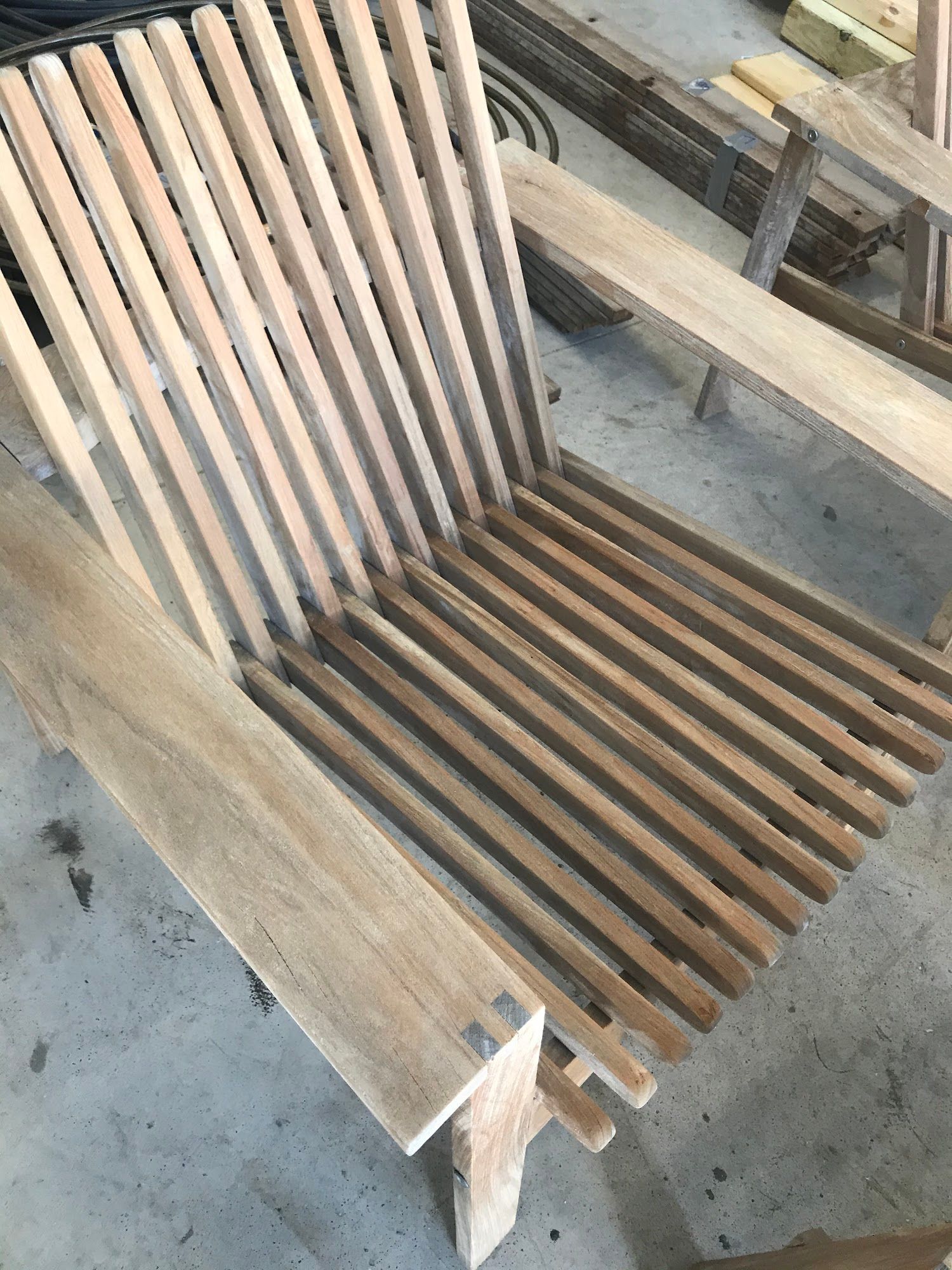 Wooden chair with slatted seat and back, outdoors.