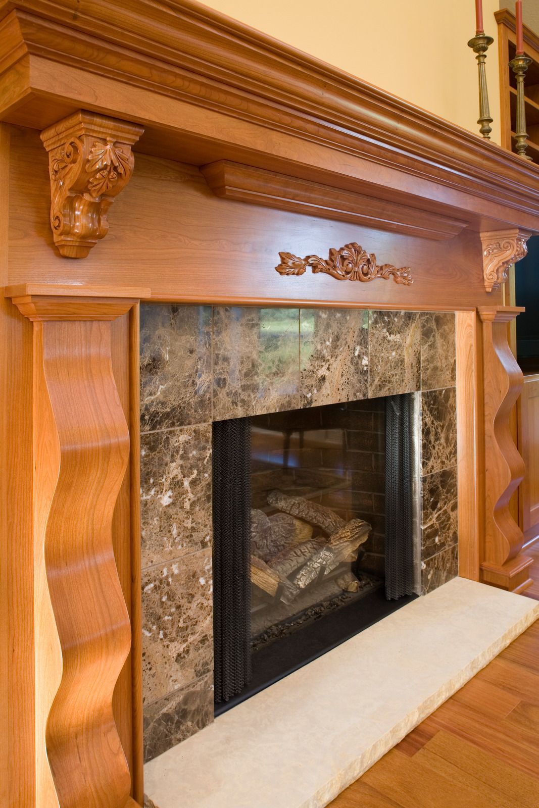 Wooden tiered plant display tables with potted plants outdoors at night.