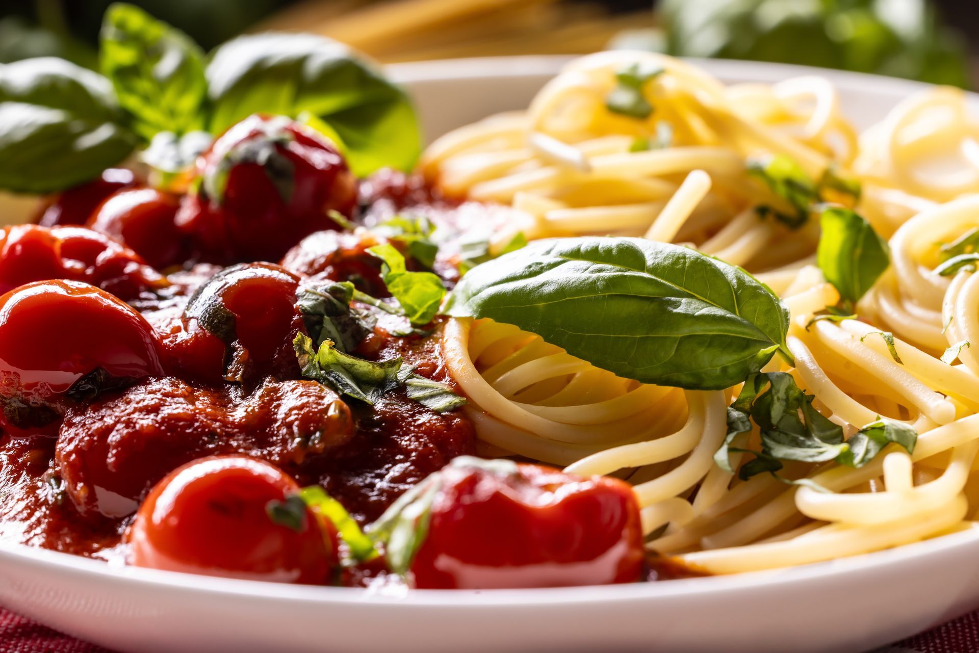 Spaghetti with tomato sauce, basil and parmesan on a white plate. Spaghetti with tomato sauce, basil and parmesan on a white plate.