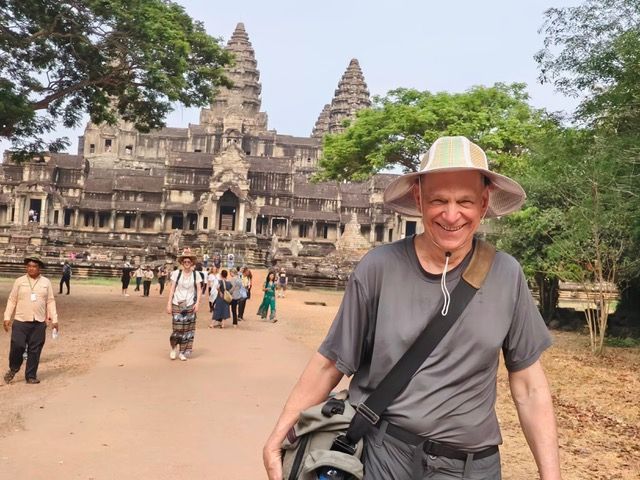 Traveler exploring the ancient Angkor Wat temple complex in Siem Reap Cambodia
