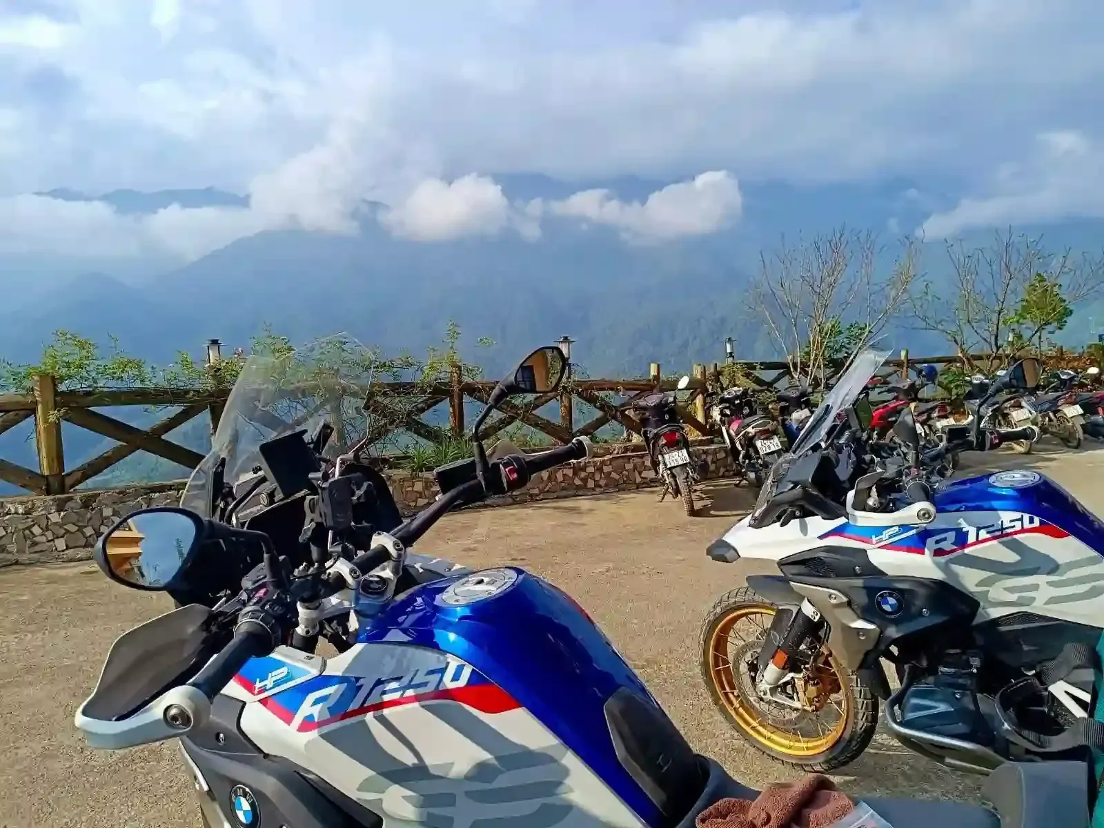 BMW R1250GS motorbikes parked at a mountain viewpoint during Thailand motorbike tour