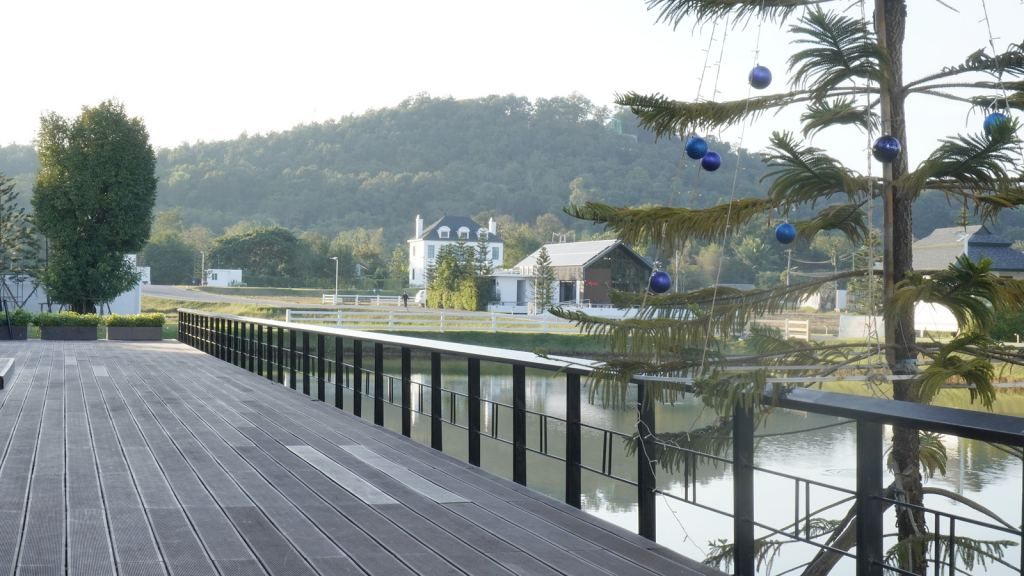 Scenic wooden deck overlooking water and hills at a boutique accommodation in Northern Thailand