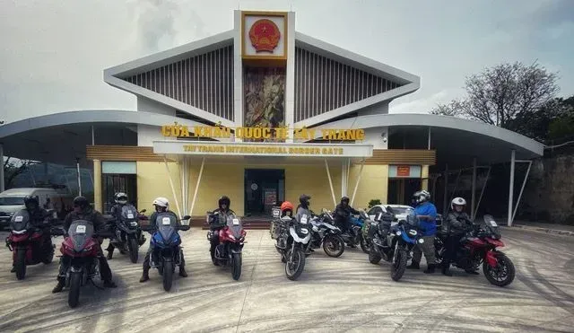 Bike Tour Asia riders lined up at Tay Trang International Border Gate between Vietnam and Laos