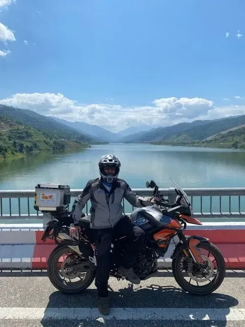 Bike Tour Asia rider posing beside a scenic river in northern Vietnam