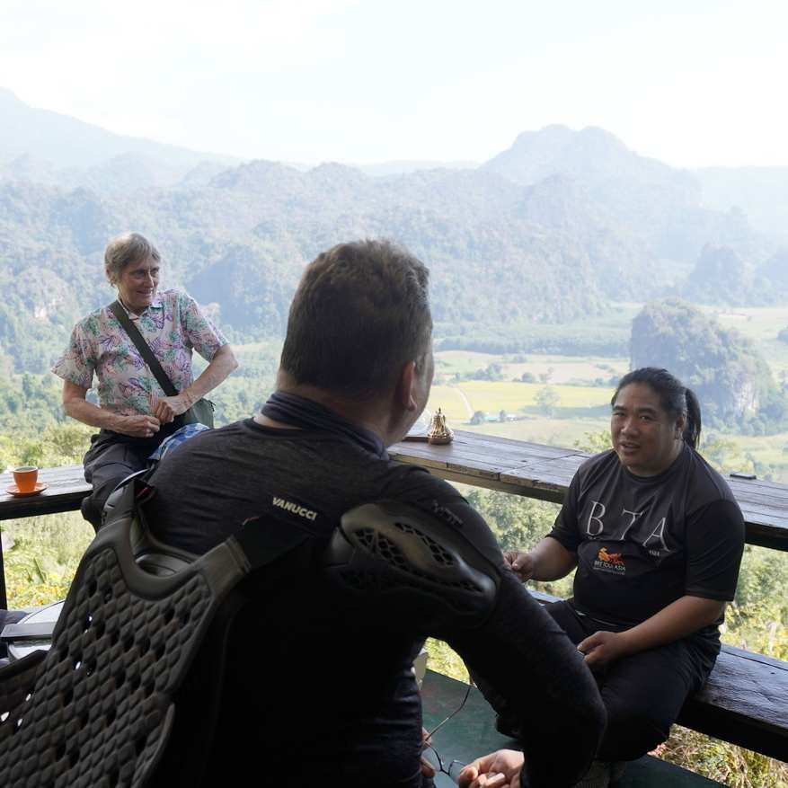 Motorcycle tour group taking a break at a scenic mountain viewpoint in Northern Thailand