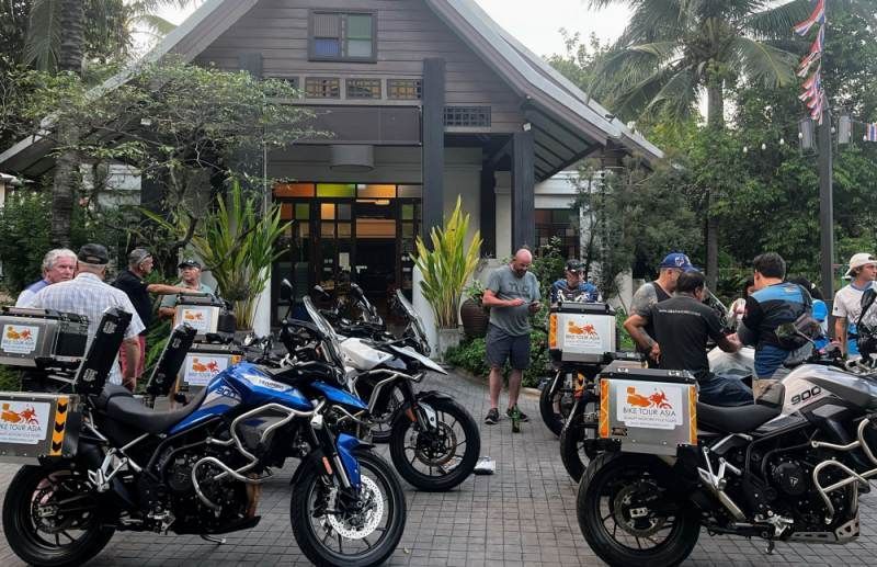 Bike Tour Asia riders preparing their Triumph motorcycles outside a resort in Thailand before the start of a group tour.