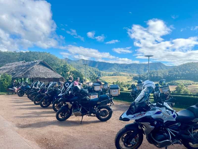 Adventure motorcycles parked at a scenic mountain viewpoint in Northern Thailand