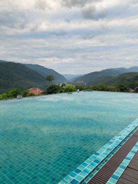 Mountain view infinity pool at scenic resort in northern Thailand